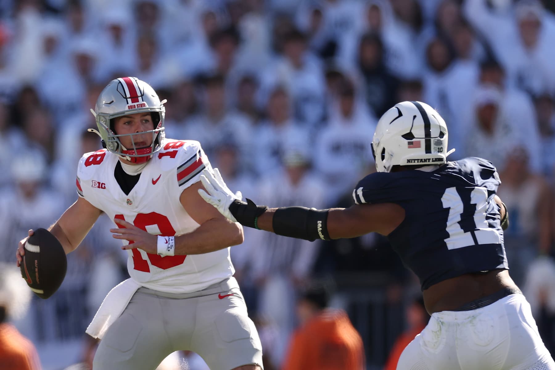 STATE COLLEGE, PENNSYLVANIA - NOVEMBER 02: Will Howard #18 of the Ohio State Buckeyes is pressured by Abdul Carter #11 of the Penn State Nittany Lions during the second quarter at Beaver Stadium on November 02, 2024 in State College, Pennsylvania. (Photo by Scott Taetsch/Getty Images) STATE COLLEGE, PENNSYLVANIA - NOVEMBER 02: Will Howard #18 of the Ohio State Buckeyes is pressured by Abdul Carter #11 of the Penn State Nittany Lions during the second quarter at Beaver Stadium on November 02, 2024 in State College, Pennsylvania. (Photo by Scott Taetsch/Getty Images)