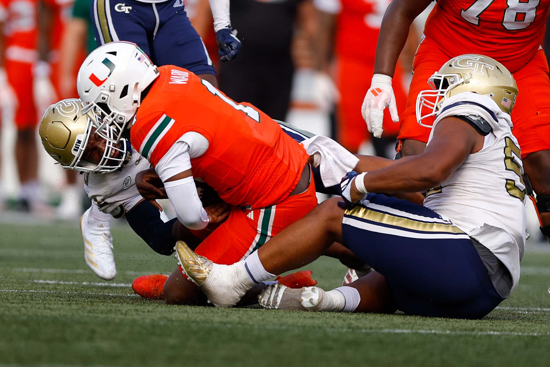 ATLANTA, GEORGIA - NOVEMBER 9: Cam Ward #1 of the Miami Hurricanes is sacked by Thomas Gore #59 and Mishael Powell #0 of the Miami Hurricanes during the fourth quarter at Bobby Dodd Stadium on November 9, 2024 in Atlanta, Georgia. (Photo by Todd Kirkland/Getty Images)