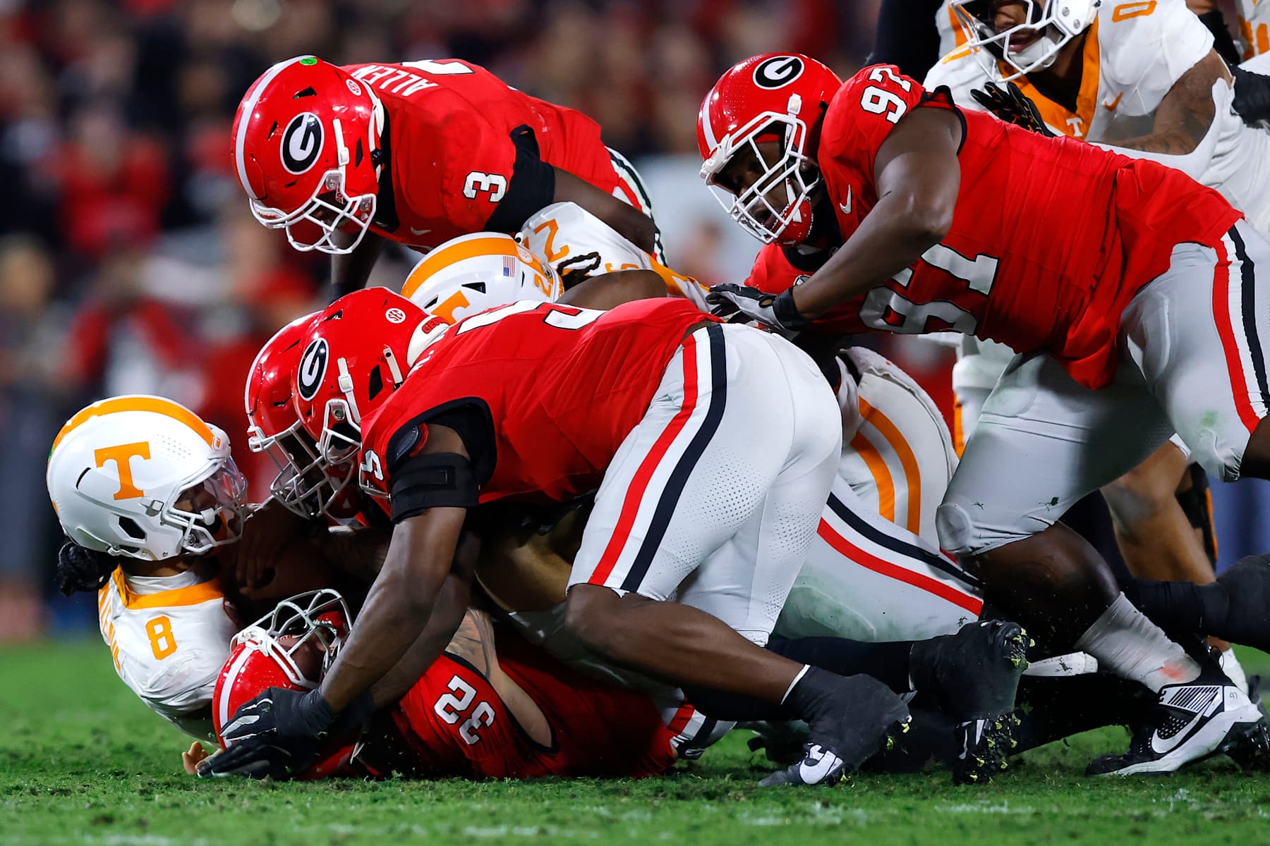 ATHENS, GEORGIA - NOVEMBER 16: Nico Iamaleava #8 of the Tennessee Volunteers is sacked by Chaz Chambliss #32 of the Georgia Bulldogs during the first quarter at Sanford Stadium on November 16, 2024 in Athens, Georgia. (Photo by Todd Kirkland/Getty Images)