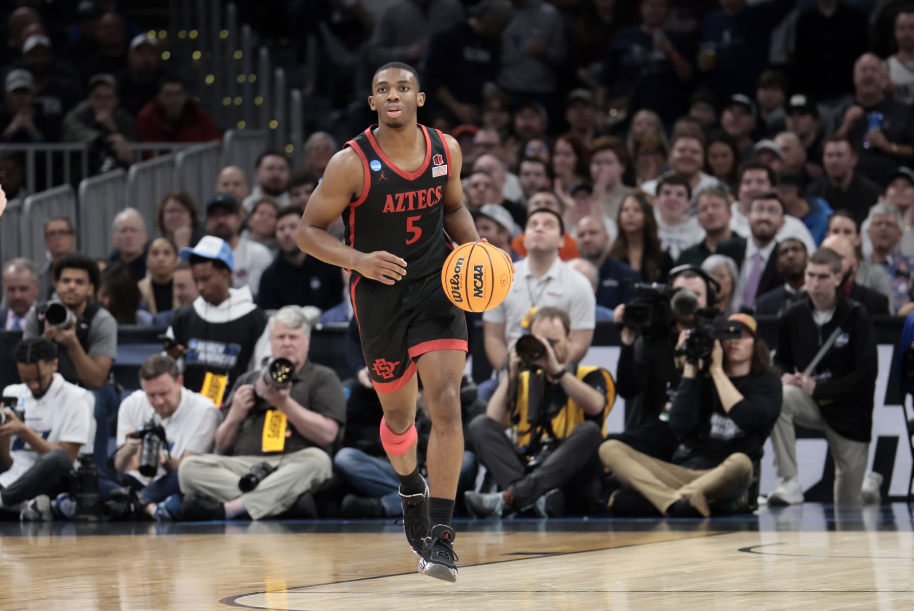 BOSTON, MA - MARCH 28: San Diego State Aztecs guard Lamont Butler (5) dribbles up court during an NCAA Sweet Sixteen game between the UCONN Huskies and the San Diego State Aztecs on March 28, 2024, at TD Garden in Boston, Massachusetts. (Photo by Fred Kfoury III/Icon Sportswire via Getty Images)