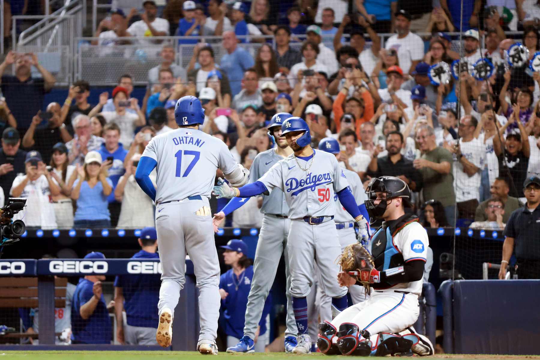 MIAMI, FL - SEPTEMBER 17:  Shohei Ohtani #17 of the Los Angeles Dodgers is greeted by teammate Mookie Betts #50 after hitting a two-run home run in the third inning during the game between the Los Angeles Dodgers and the Miami Marlins at loanDepot park on Tuesday, September 17, 2024 in Miami, Florida. (Photo by Kelly Gavin/MLB Photos via Getty Images)