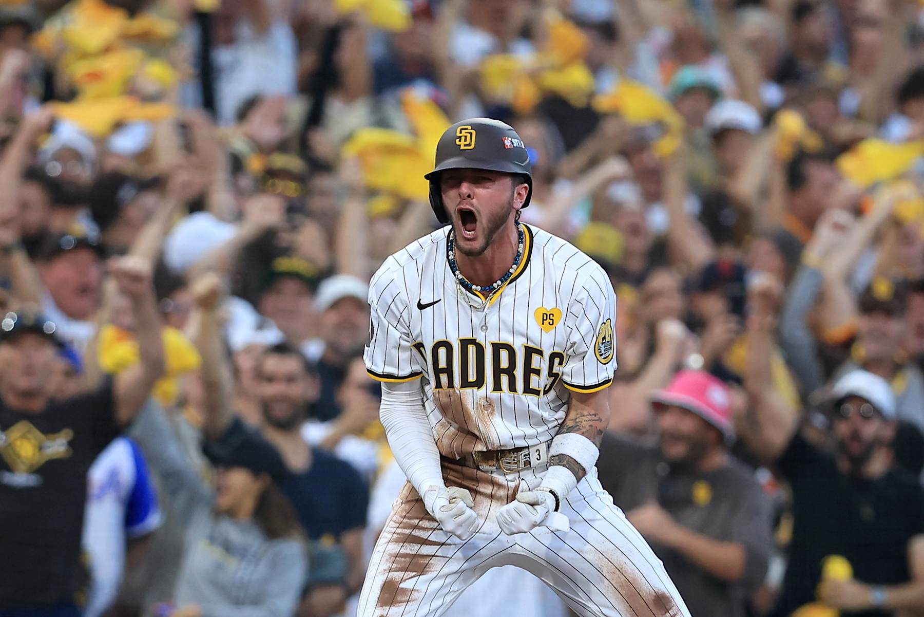SAN DIEGO, CALIFORNIA - OCTOBER 02: Jackson Merrill #3 of the San Diego Padres celebrates from third base after hitting a two run RBI triple against the Atlanta Braves during the second inning in Game Two of the Wild Card Series at Petco Park on October 02, 2024 in San Diego, California.  (Photo by Sean M. Haffey/Getty Images)