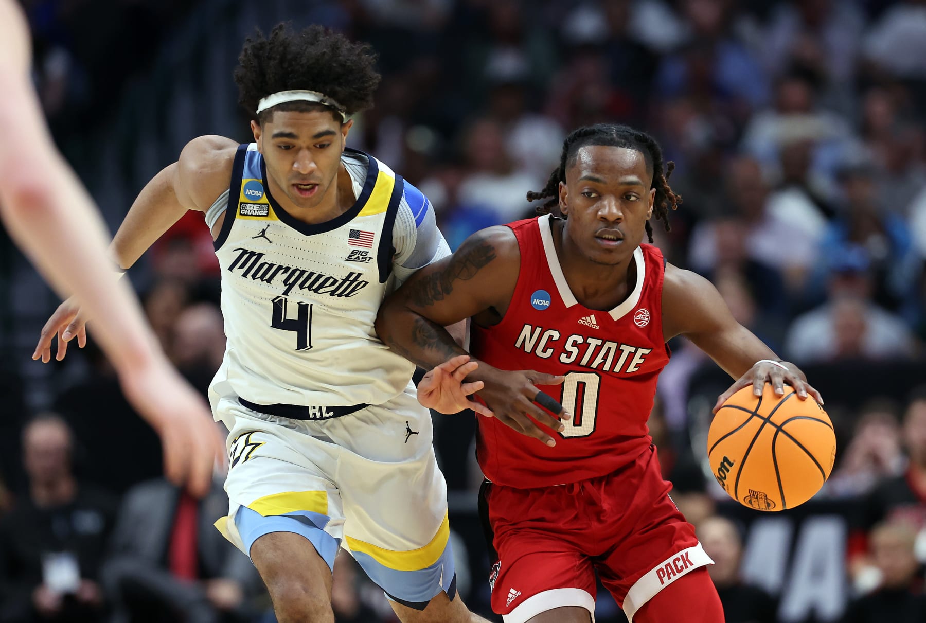 DALLAS, TEXAS - MARCH 29: DJ Horne #0 of the North Carolina State Wolfpack dribbles the ball against Stevie Mitchell #4 of the Marquette Golden Eagles during the first half in the Sweet 16 round of the NCAA Men's Basketball Tournament at American Airlines Center on March 29, 2024 in Dallas, Texas. (Photo by Patrick Smith/Getty Images)