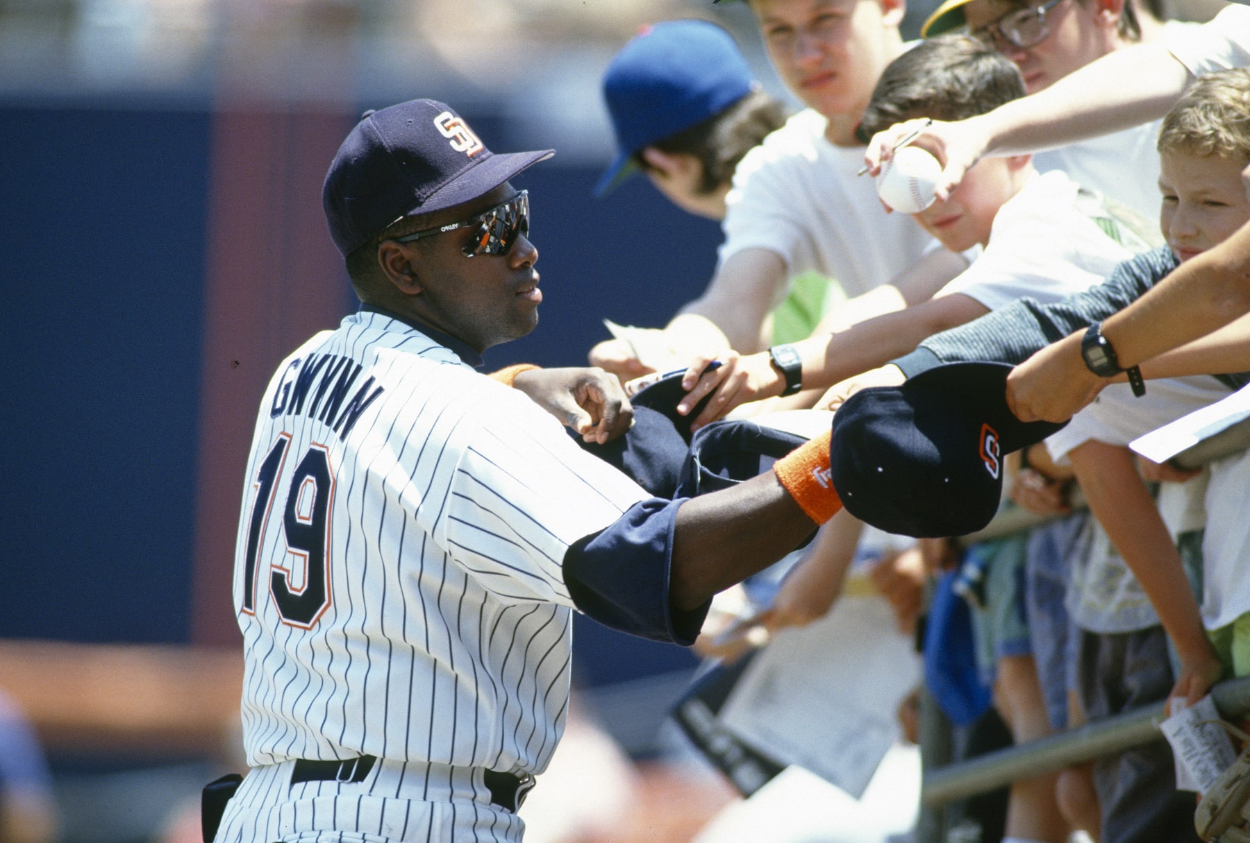 SAN DIEGO, CA - CIRCA 1992:  Tony Gwynn #19 of the San Diego Padres signs autographs for fans prior to the start of a Major League Baseball game circa 1992 at Jack Murphy Stadium in San Diego, California. Gwynn played for the Padres  from 1982-01. (Photo by Focus on Sport/Getty Images) 