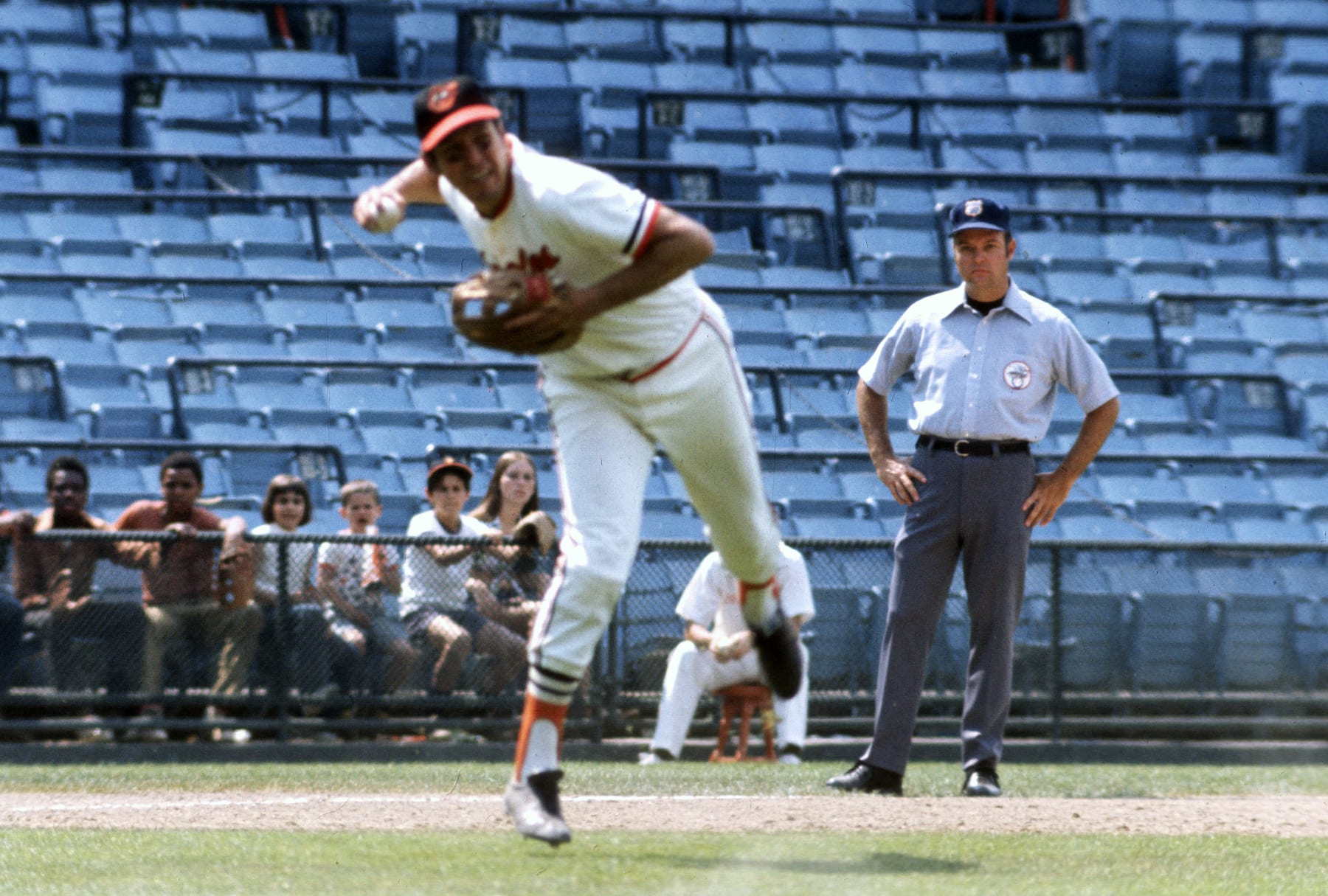 BALTIMORE, MD - CIRCA 1971: Brooks Robinson #5 of the Baltimore Orioles in action making an off balance throw to first base during an Major League Baseball game circa 1971 at Memorial Stadium in Baltimore, Maryland. Robinson played for the Orioles from 1955-77. (Photo by Focus on Sport/Getty Images)