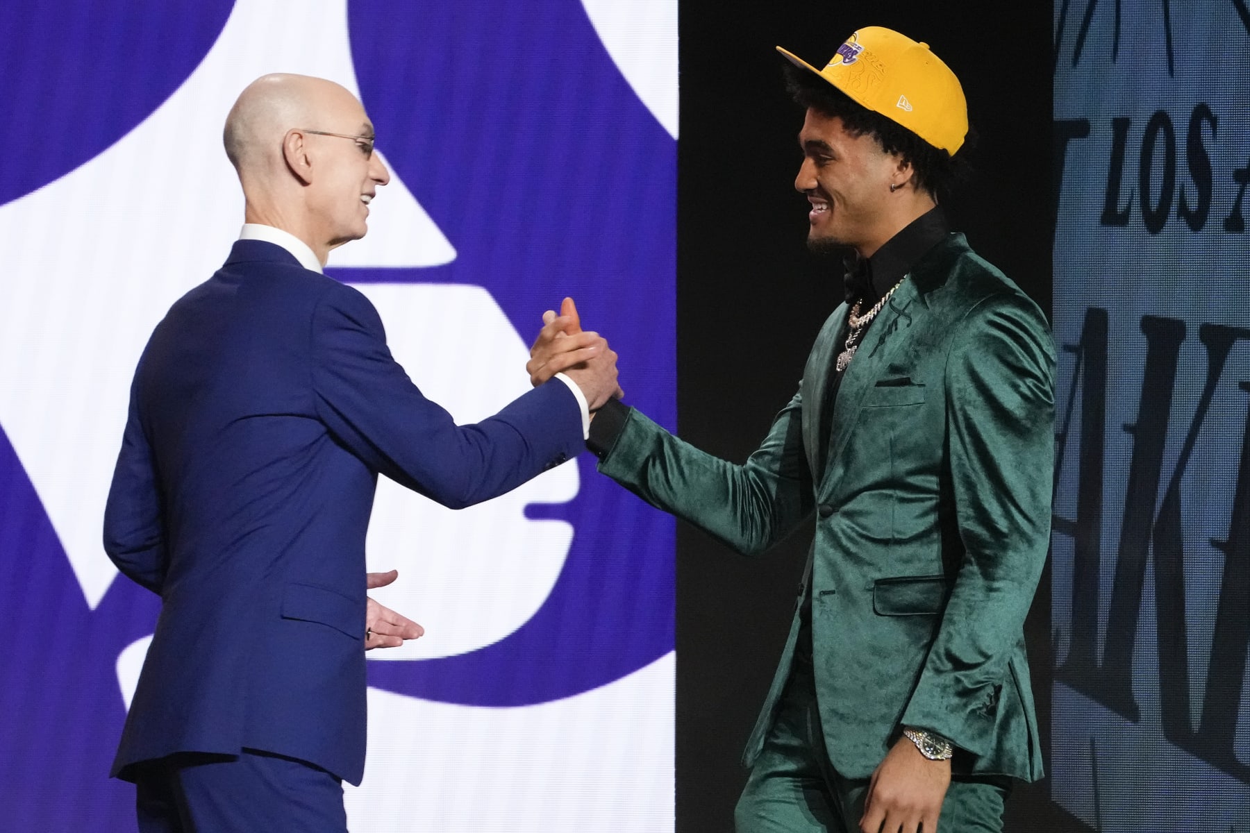 Jalen Hood-Schifino greets NBA Commissioner Adam Silver after being selected 17th overall by the Los Angeles Lakers during the NBA basketball draft, Thursday, June 22, 2023, in New York. (AP Photo/John Minchillo)
