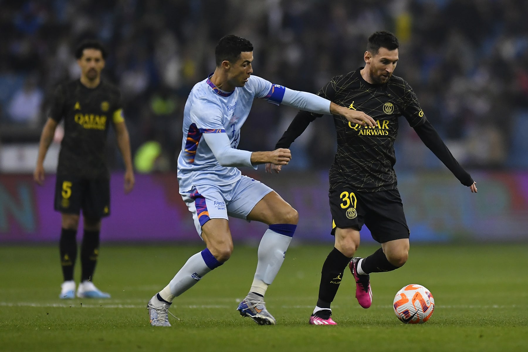 RIYADH, SAUDI ARABIA - JANUARY 19: Leo Messi of Paris Saint-Germain and Cristiano Ronaldo of Ruyadh XI fight for possession during the friendly match between Paris Saint-Germain and Riyadh XI at King Fahd International Stadium on January 19, 2023 in Riyadh, Saudi Arabia. (Photo by Aurelien Meunier - PSG/PSG via Getty Images)