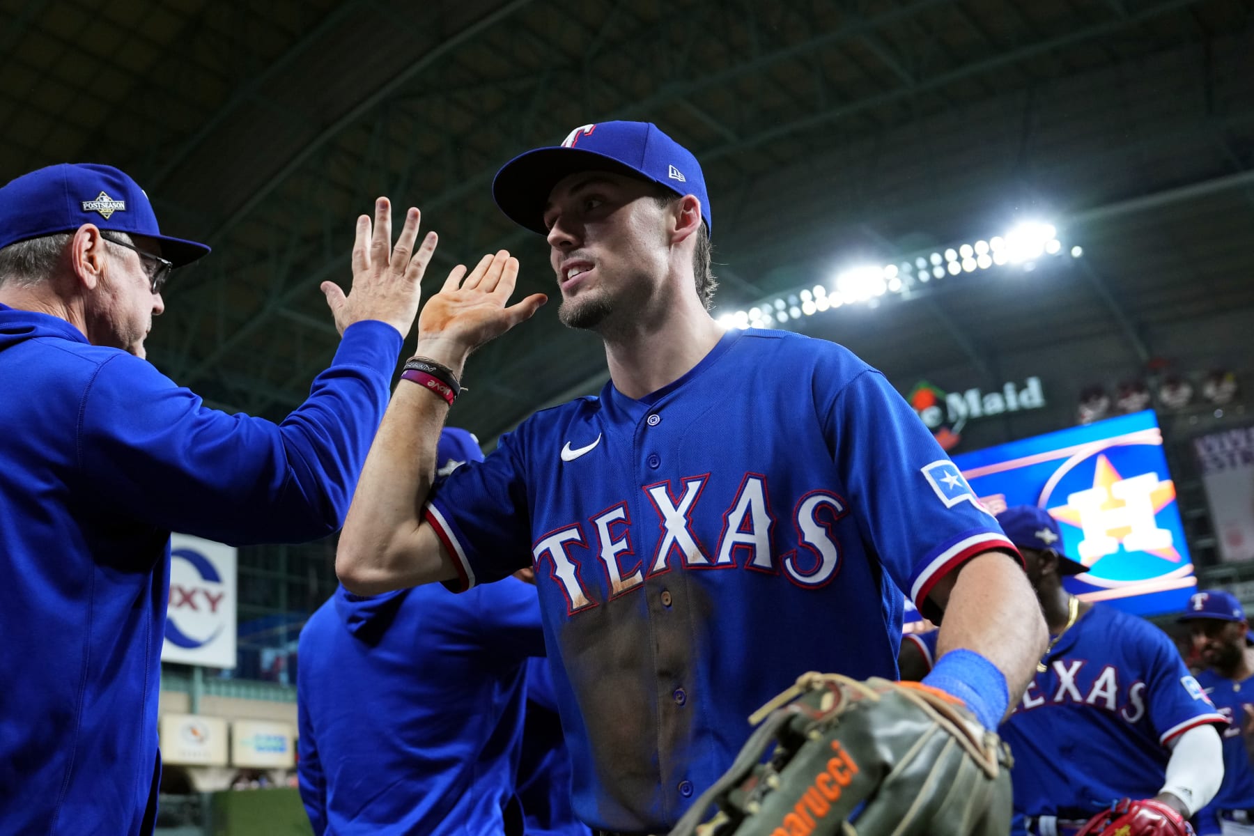 HOUSTON, TX - OCTOBER 22:  Evan Carter #32 of the Texas Rangers celebrates with teammates after the Rangers defeated the Houston Astros in Game 6 of the ALCS at Minute Maid Park on Sunday, October 22, 2023 in Houston, Texas. (Photo by Alex Bierens de Haan/MLB Photos via Getty Images)