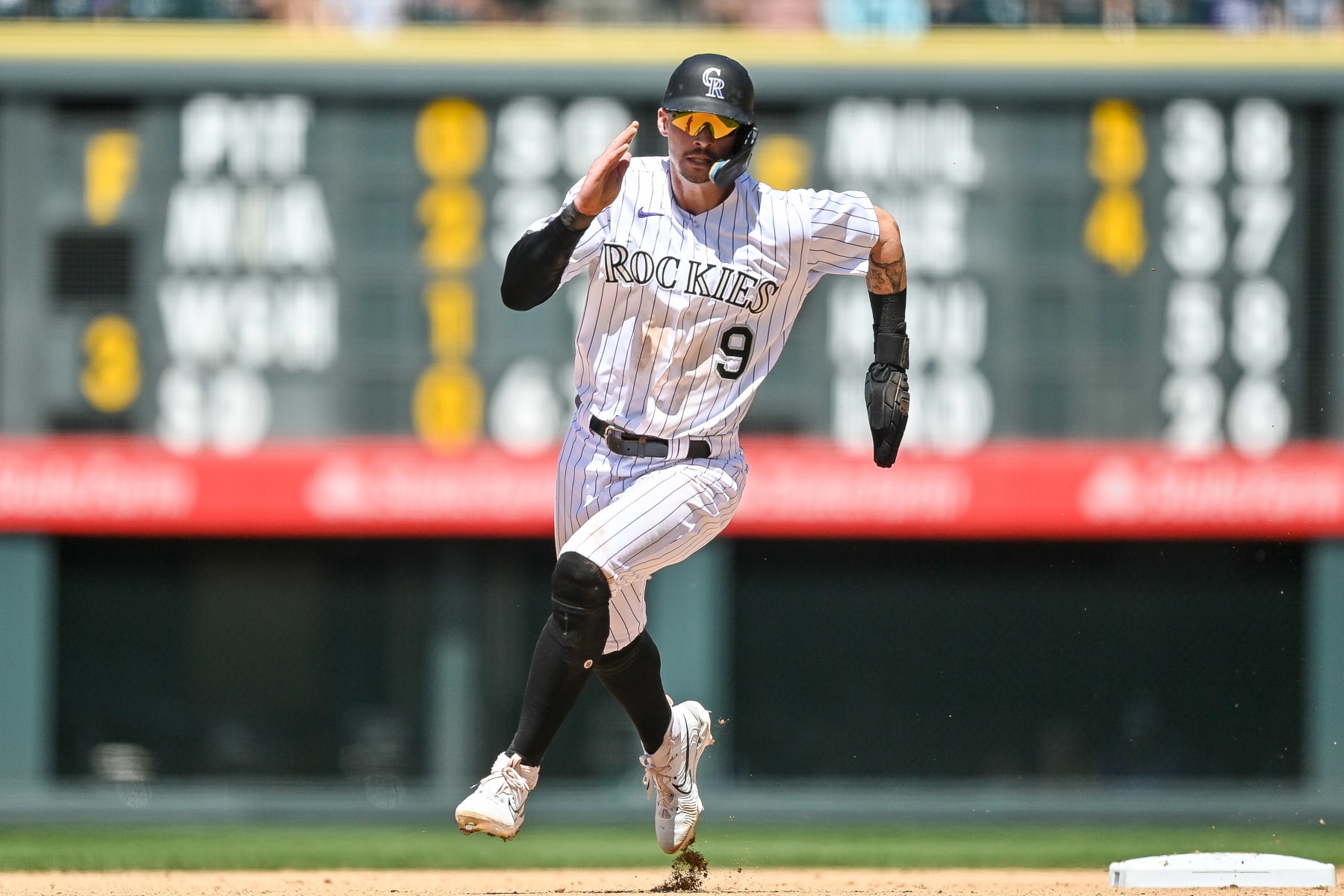 DENVER, CO - JUNE 25: Brenton Doyle #9 of the Colorado Rockies advances from first to third after a failed pickoff attempt in the seventh inning of a game against the Los Angeles Angels at Coors Field on June 25, 2023 in Denver, Colorado. (Photo by Dustin Bradford/Getty Images)