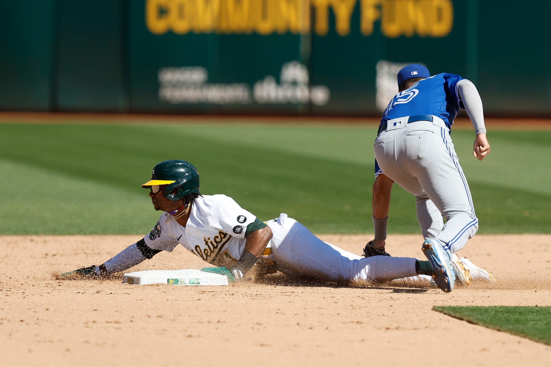 OAKLAND, CALIFORNIA - SEPTEMBER 04: Esteury Ruiz (L) #1 of the Oakland Athletics steals second base in the bottom of the ninth inning against the Toronto Blue Jays at RingCentral Coliseum on September 04, 2023 in Oakland, California. (Photo by Lachlan Cunningham/Getty Images)