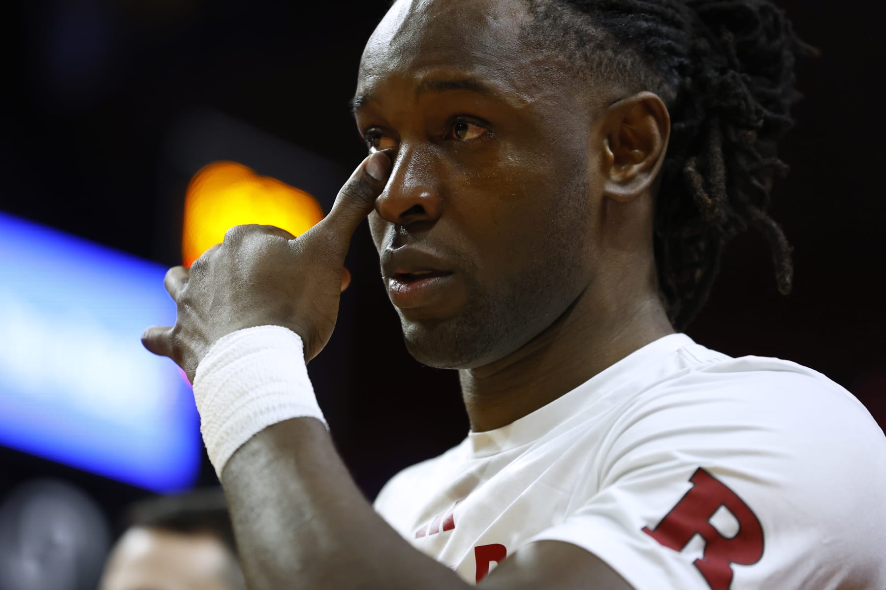 PISCATAWAY, NEW JERSEY - MARCH 10: Clifford Omoruyi #11 of the Rutgers Scarlet Knights wipes a tear from his eye during a senior day ceremony before the start of a game against the Ohio State Buckeyes at Jersey Mike's Arena on March 10, 2024 in Piscataway, New Jersey. (Photo by Rich Schultz/Getty Images)