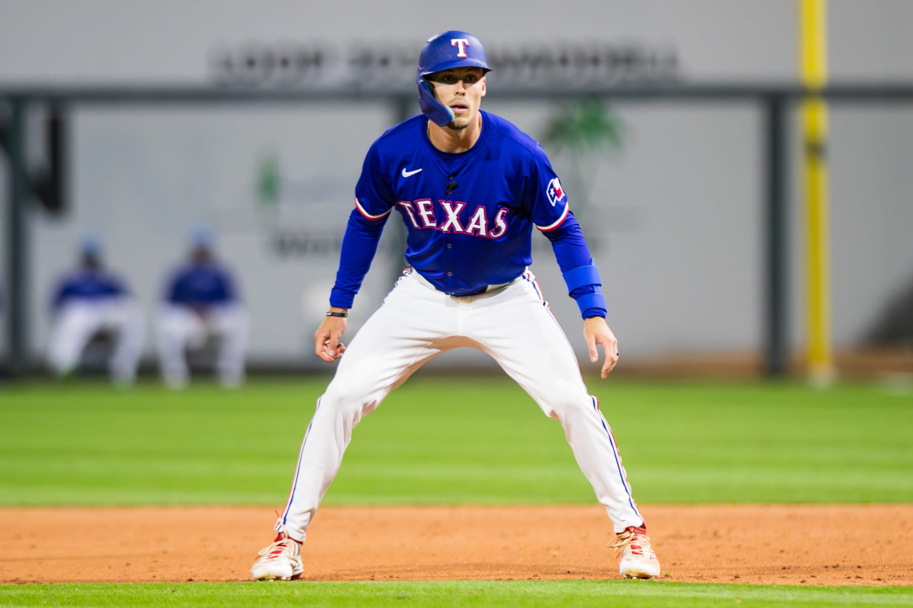 SURPRISE, ARIZONA - MARCH 14: Evan Carter #32 of the Texas Rangers takes a lead off of first base during the Spring Training Game against the Cincinnati Reds at Surprise Stadium on March 14, 2024 in Surprise, Arizona. (Photo by John E. Moore III/Getty Images)