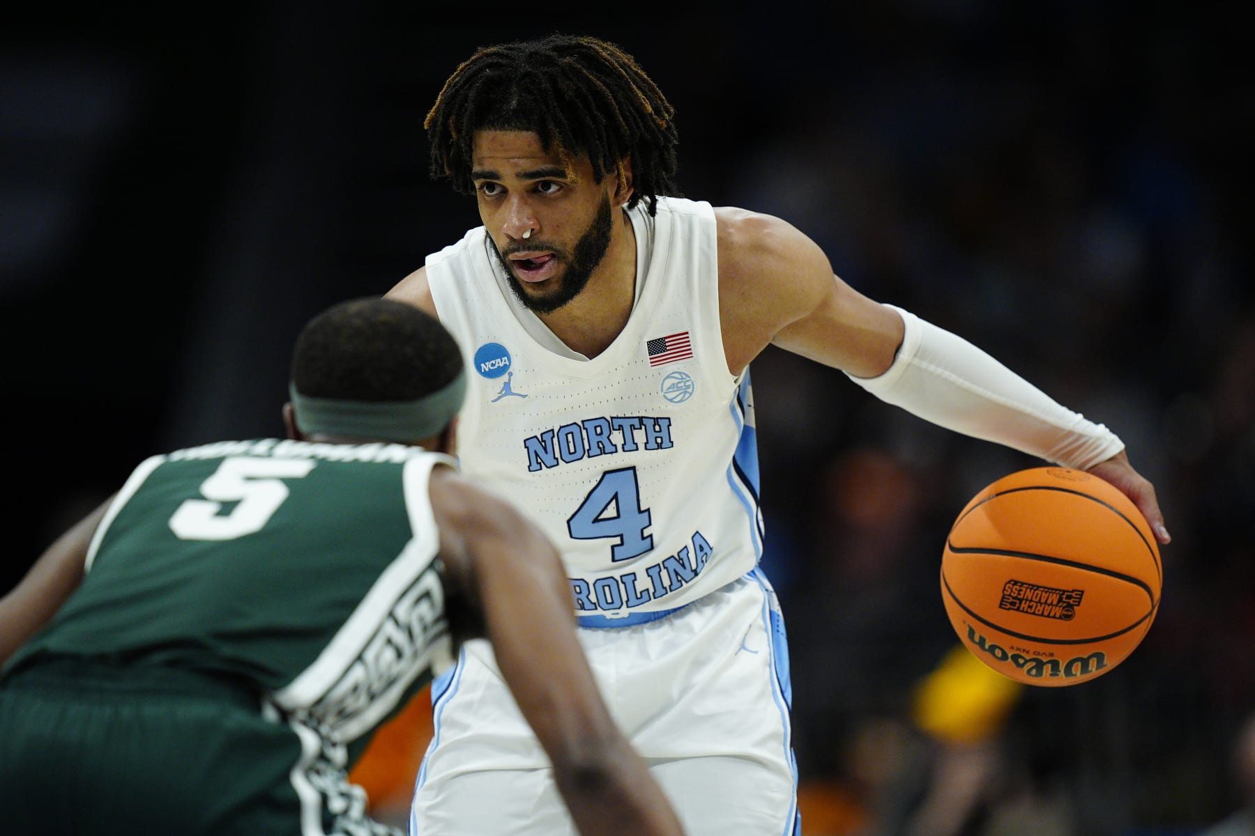 CHARLOTTE, NORTH CAROLINA - MARCH 23: RJ Davis #4 of the North Carolina Tar Heels handles the ball against Tre Holloman #5 of the Michigan State Spartans during the second half in the second round of the NCAA Men's Basketball Tournament at Spectrum Center on March 23, 2024 in Charlotte, North Carolina. (Photo by Jacob Kupferman/Getty Images)