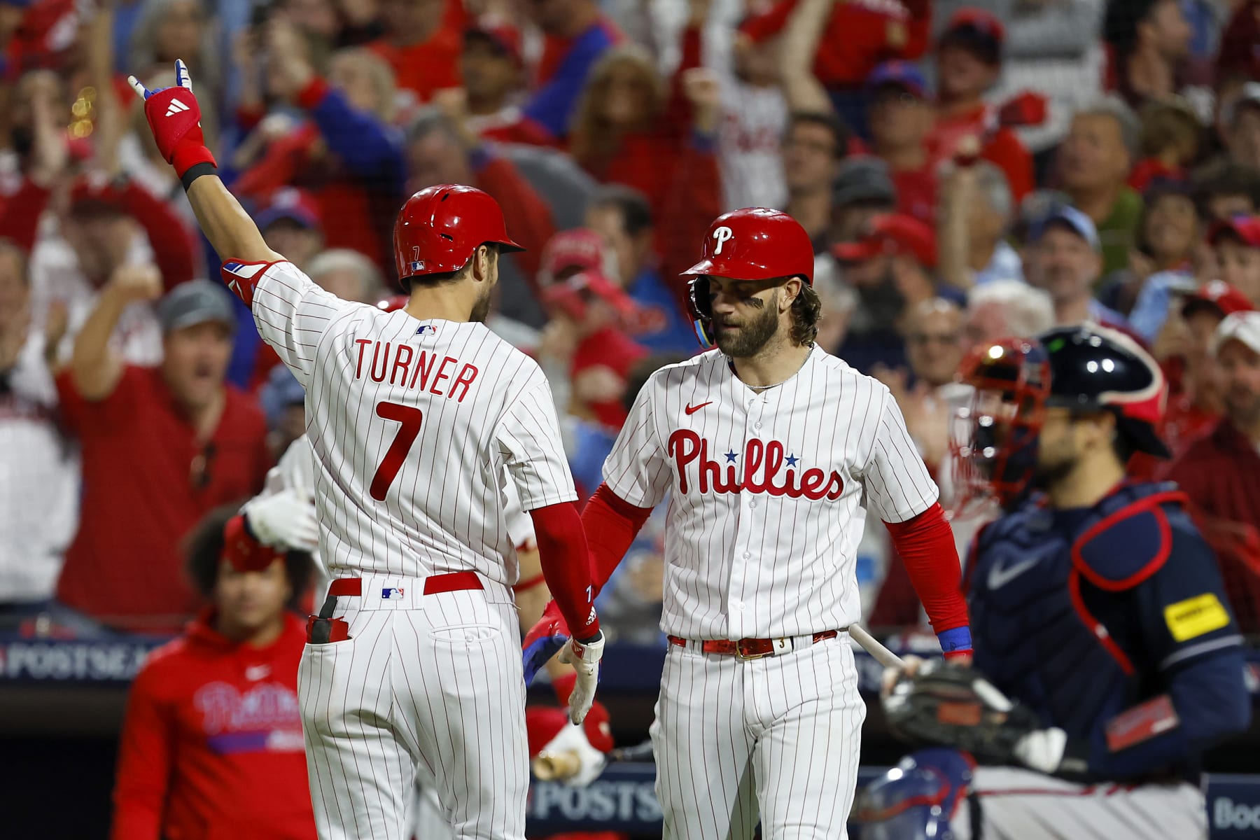 PHILADELPHIA, PENNSYLVANIA - OCTOBER 11: Trea Turner #7 of the Philadelphia Phillies celebrates with Bryce Harper #3 after hitting a solo home run against the Atlanta Braves during the sixth inning in Game Three of the Division Series at Citizens Bank Park on October 11, 2023 in Philadelphia, Pennsylvania. (Photo by Rich Schultz/Getty Images)
