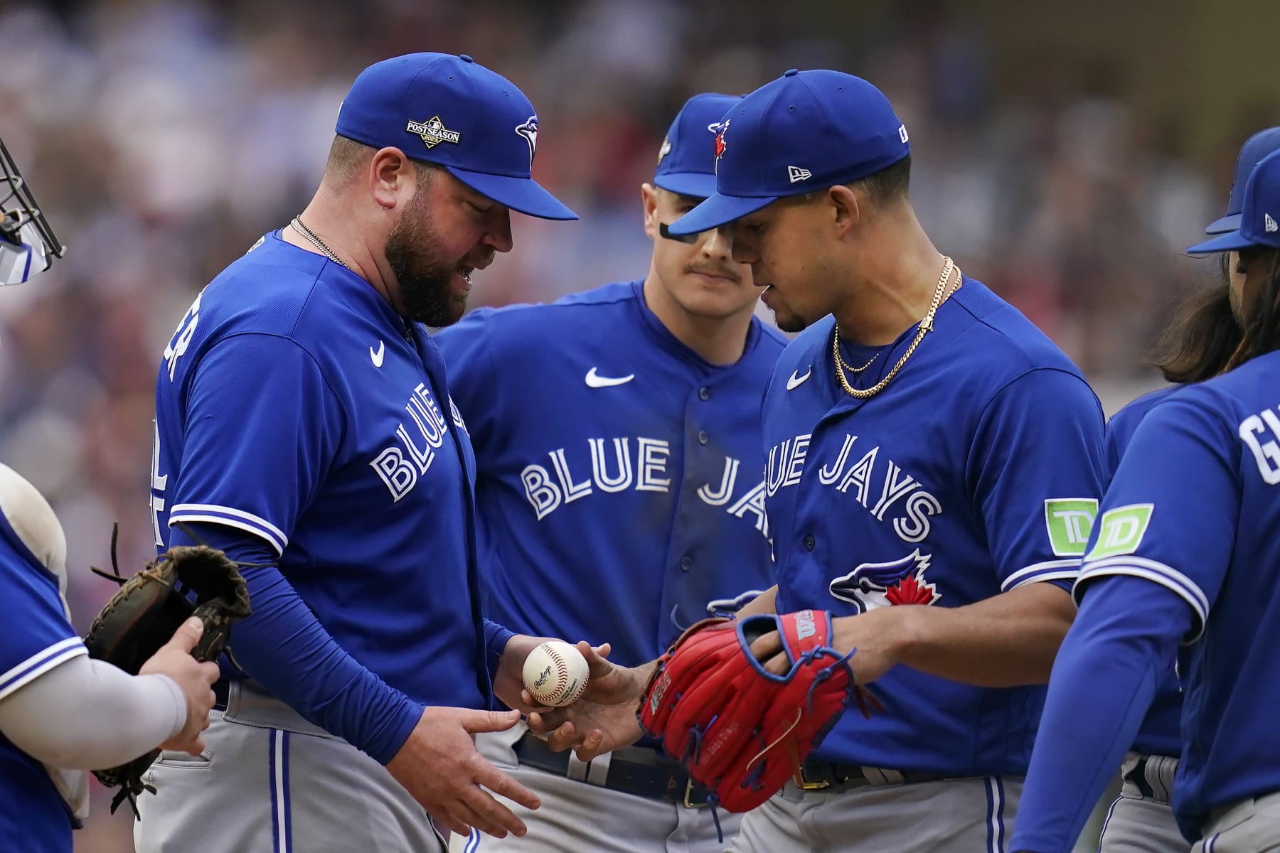 Toronto Blue Jays manager John Schneider, left, takes the ball from pitcher Jose Berrios during a pitching change in the fourth inning of Game 2 of an AL wild-card baseball playoff series against the Minnesota Twins Wednesday, Oct. 4, 2023, in Minneapolis. (AP Photo/Abbie Parr)