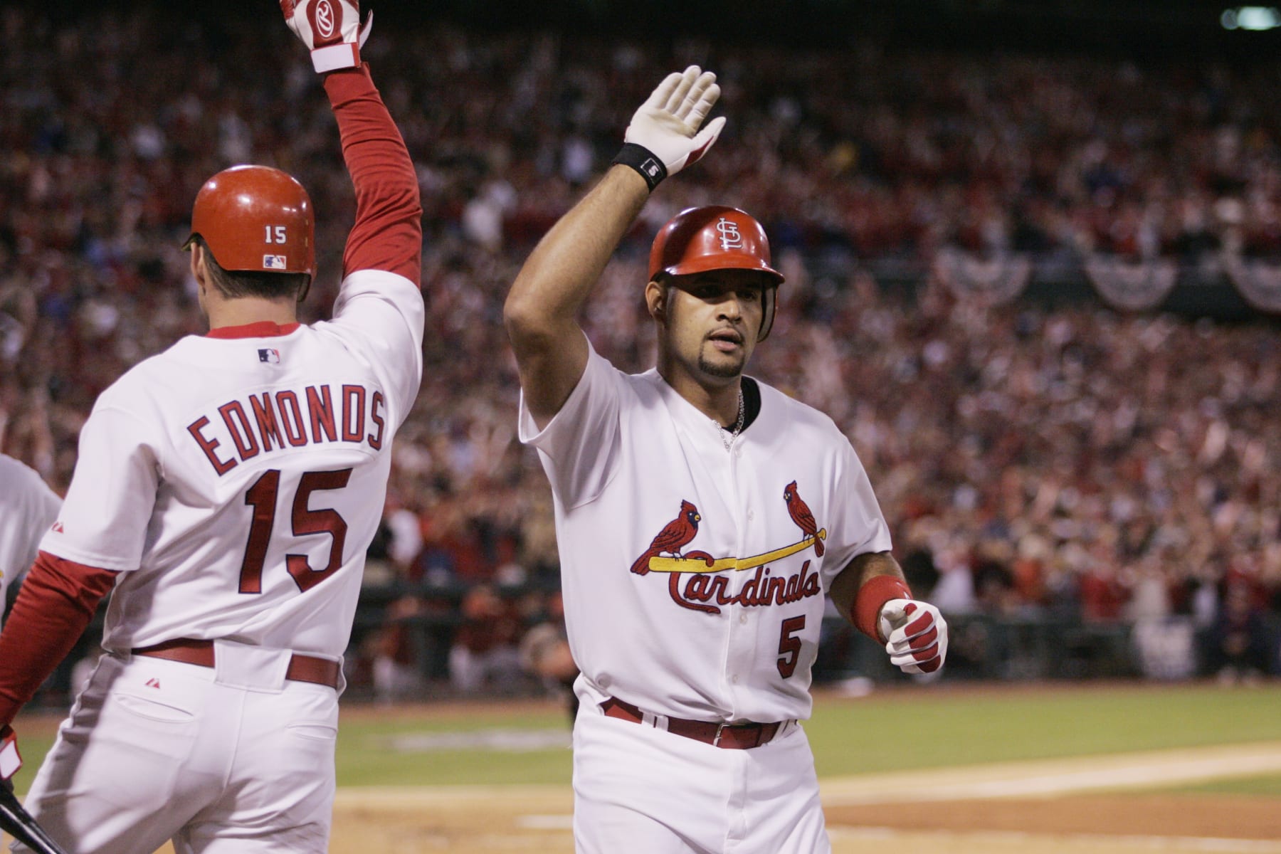 ST. LOUIS - OCTOBER 13:  Albert Pujols is congratulated by Jim Edmonds of the St. Louis Cardinals after hitting a home run during the first inning of game one of the NLCS against the Houston Astros at Busch Stadium on October 13, 2004 in St. Louis, Missouri. The Cards defeated the Astros 10-7. (Photo by Rich Pilling/MLB via Getty Images)