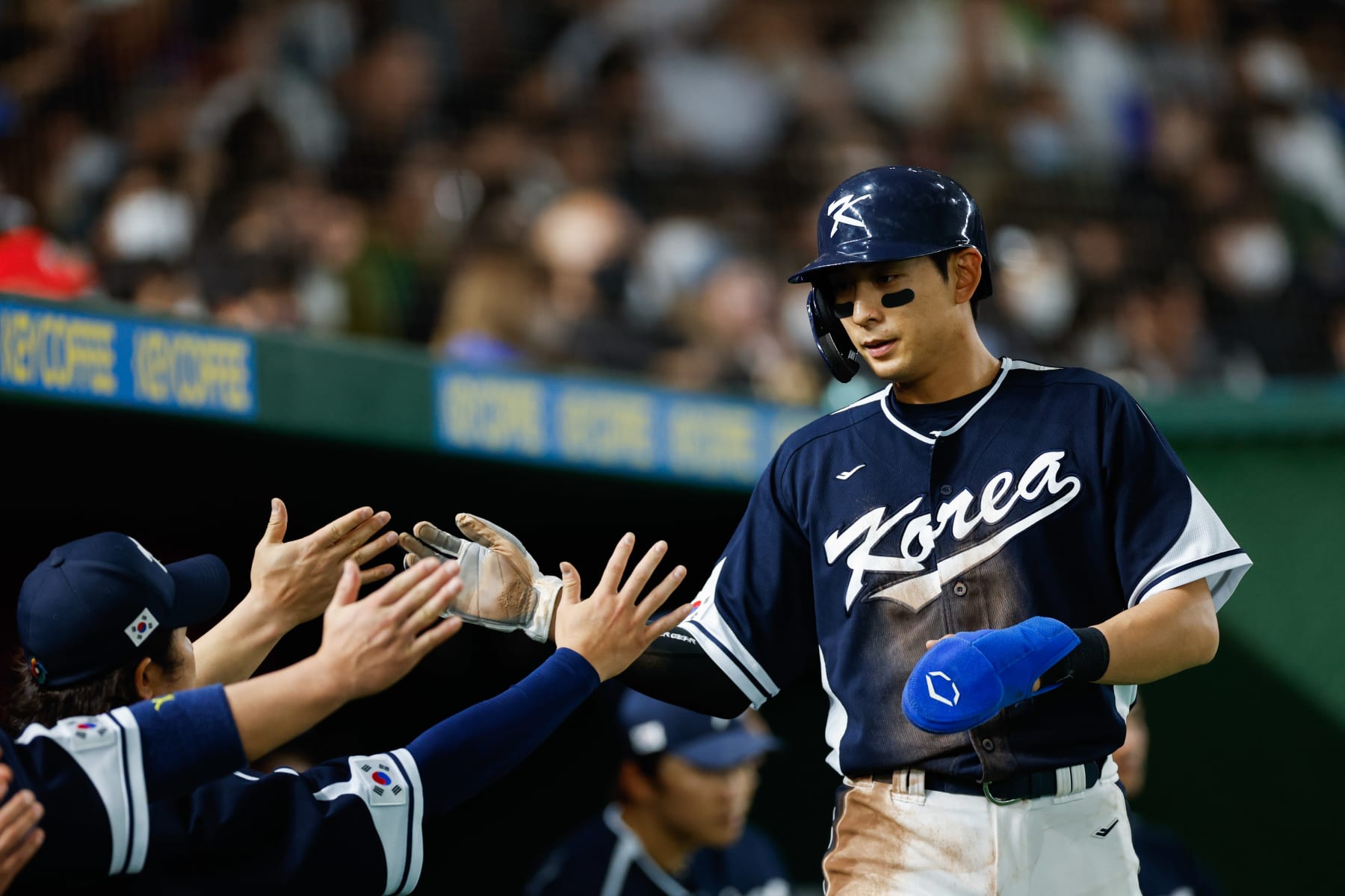 BUNKYO CITY, JAPAN - MARCH 13:   Jung Hoo Lee #51 of Team Korea high-fives teammates after scoring in the first inning during Game 10 of Pool B between Team Korea and Team China at Tokyo Dome on Monday, March 13, 2023 in Bunkyo City, Japan. (Photo by Yuki Taguchi/WBCI/MLB Photos via Getty Images)