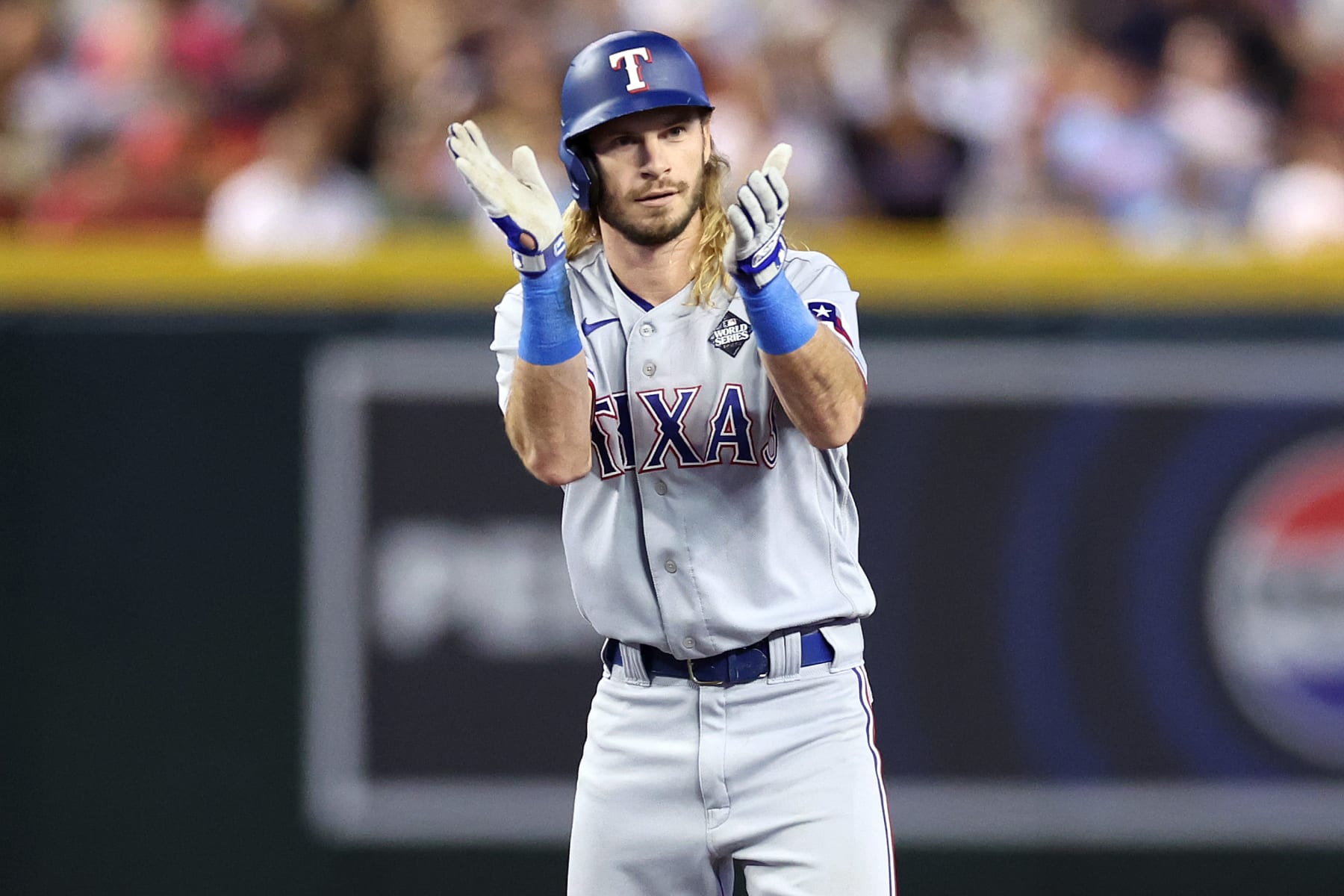PHOENIX, ARIZONA - OCTOBER 31: Travis Jankowski #16 of the Texas Rangers celebrates after hitting a double in the third inning against the Arizona Diamondbacks during Game Four of the World Series at Chase Field on October 31, 2023 in Phoenix, Arizona. (Photo by Christian Petersen/Getty Images)