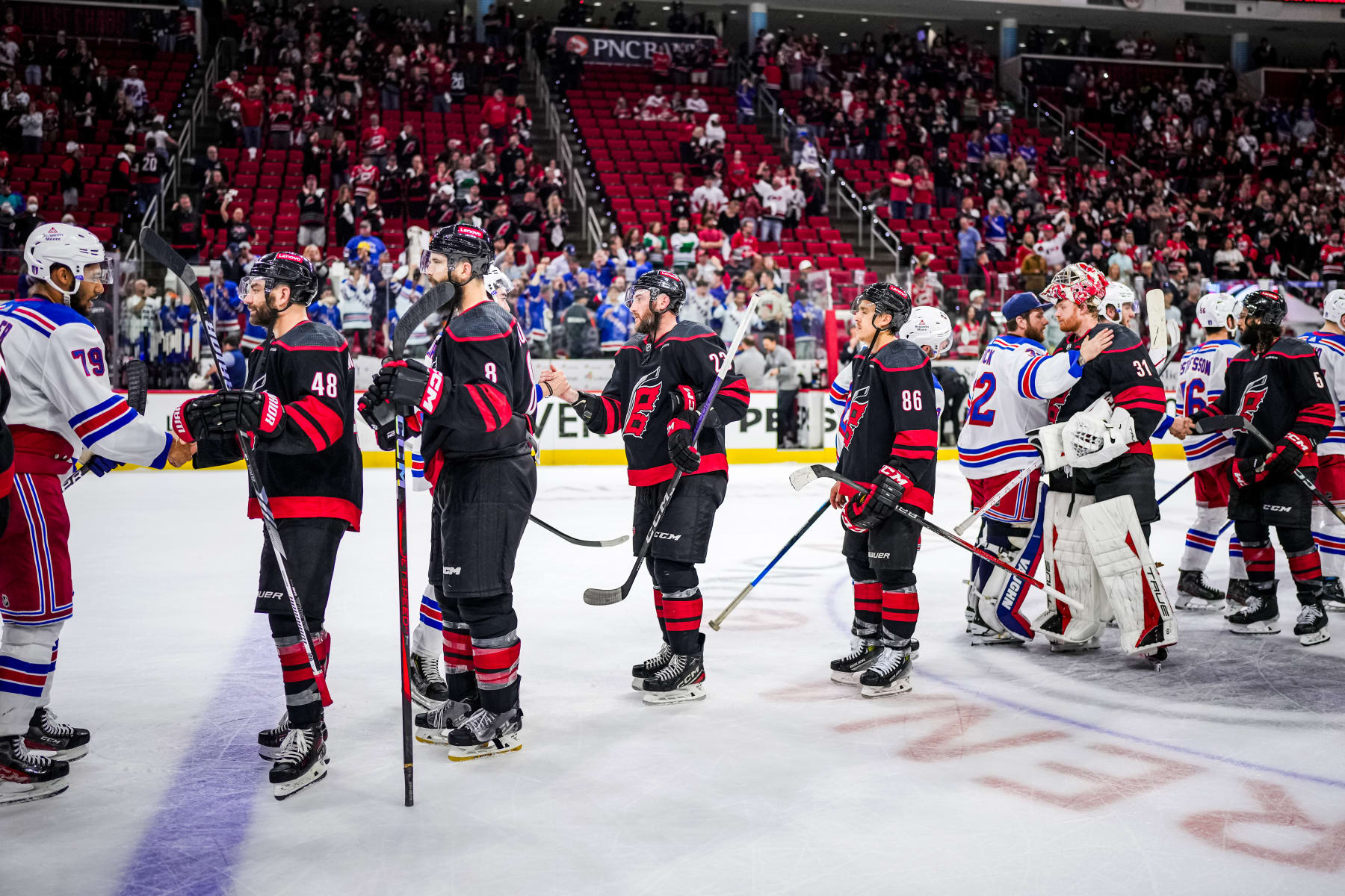 RALEIGH, NORTH CAROLINA - MAY 16: New York Rangers and Carolina Hurricanes players shake hands after Game Six of the Second Round of the 2024 Stanley Cup Playoffs at PNC Arena on May 16, 2024 in Raleigh, North Carolina.  (Photo by Josh Lavallee/NHLI via Getty Images)