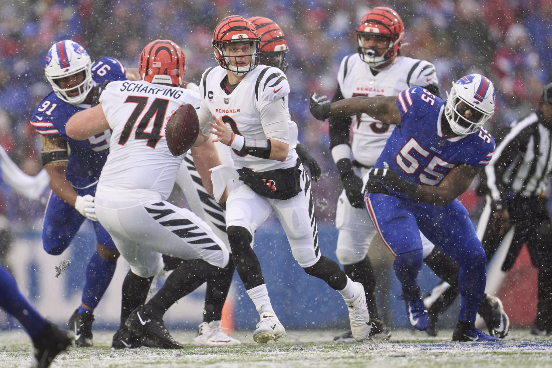 ORCHARD PARK, NY - JANUARY 22: Joe Burrow #9 of the Cincinnati Bengals scrambles against the Buffalo Bills during the first half at Highmark Stadium on January 22, 2023 in Orchard Park, New York. (Photo by Cooper Neill/Getty Images)
