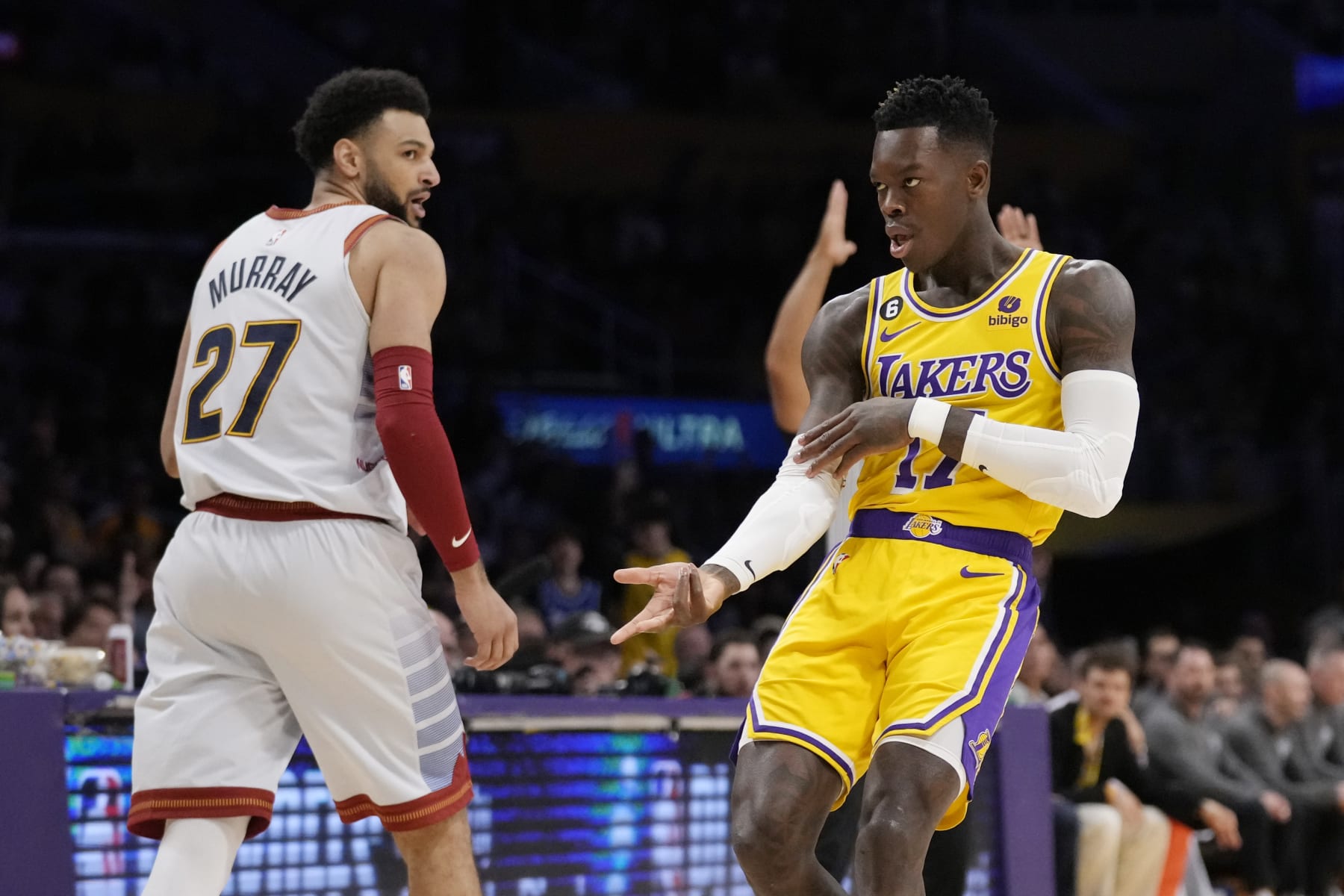 Los Angeles Lakers guard Dennis Schroder, right, reacts after making a 3-point basket next to Denver Nuggets guard Jamal Murray (27) in the first half of Game 4 of the NBA basketball Western Conference Final series Monday, May 22, 2023, in Los Angeles. (AP Photo/Ashley Landis)