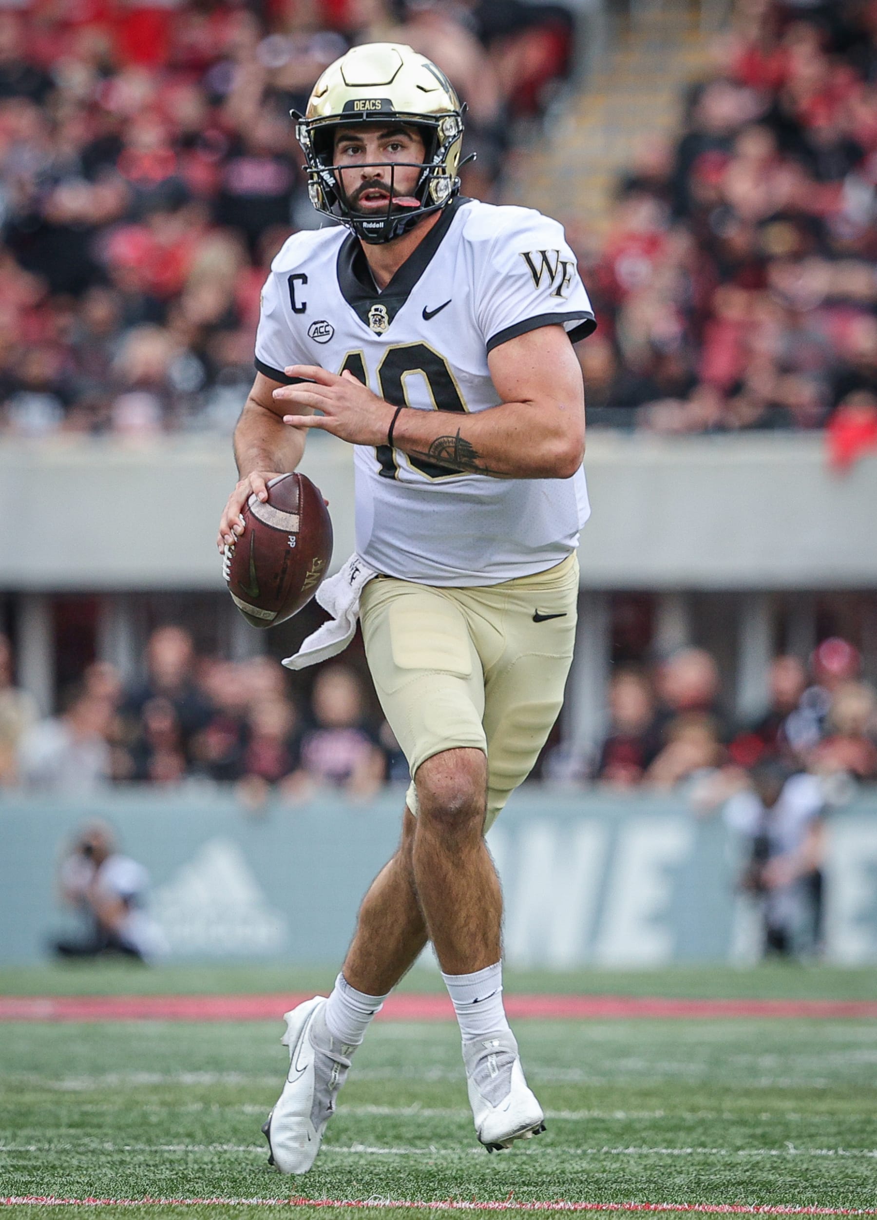 LOUISVILLE, KY - OCTOBER 29: Sam Hartman #10 of the Wake Forest Demon Deacons runs the ball during the game against the Louisville Cardinals at Cardinal Stadium on October 29, 2022 in Louisville, Kentucky. (Photo by Michael Hickey/Getty Images)