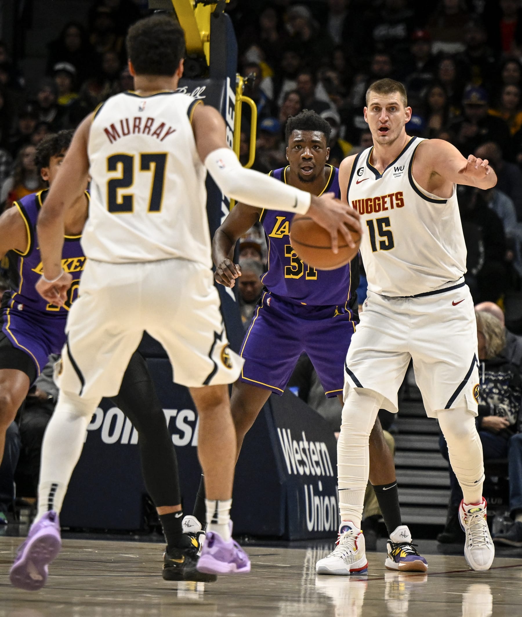DENVER, CO - JANUARY 9: Nikola Jokic (15) of the Denver Nuggets looks for a pass from Jamal Murray (27) as Thomas Bryant (31) of the Los Angeles Lakers defends Jokic during the first quarter at Ball Arena in Denver on Monday, January 9, 2023. (Photo by AAron Ontiveroz/MediaNews Group/The Denver Post via Getty Images)