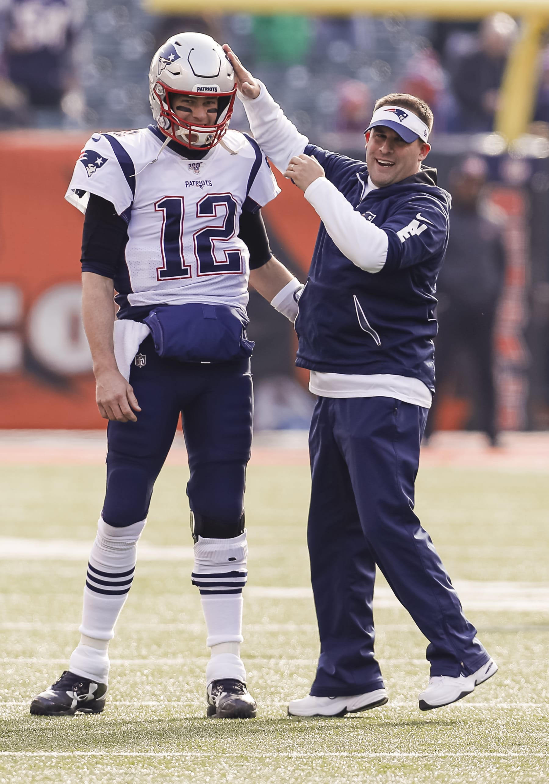 CINCINNATI, OH - DECEMBER 15: Tom Brady #12 and Josh McDaniels offensive coordinator for the New England Patriots talk before the game against the Cincinnati Bengals at Paul Brown Stadium on December 15, 2019 in Cincinnati, Ohio. (Photo by Michael Hickey/Getty Images)