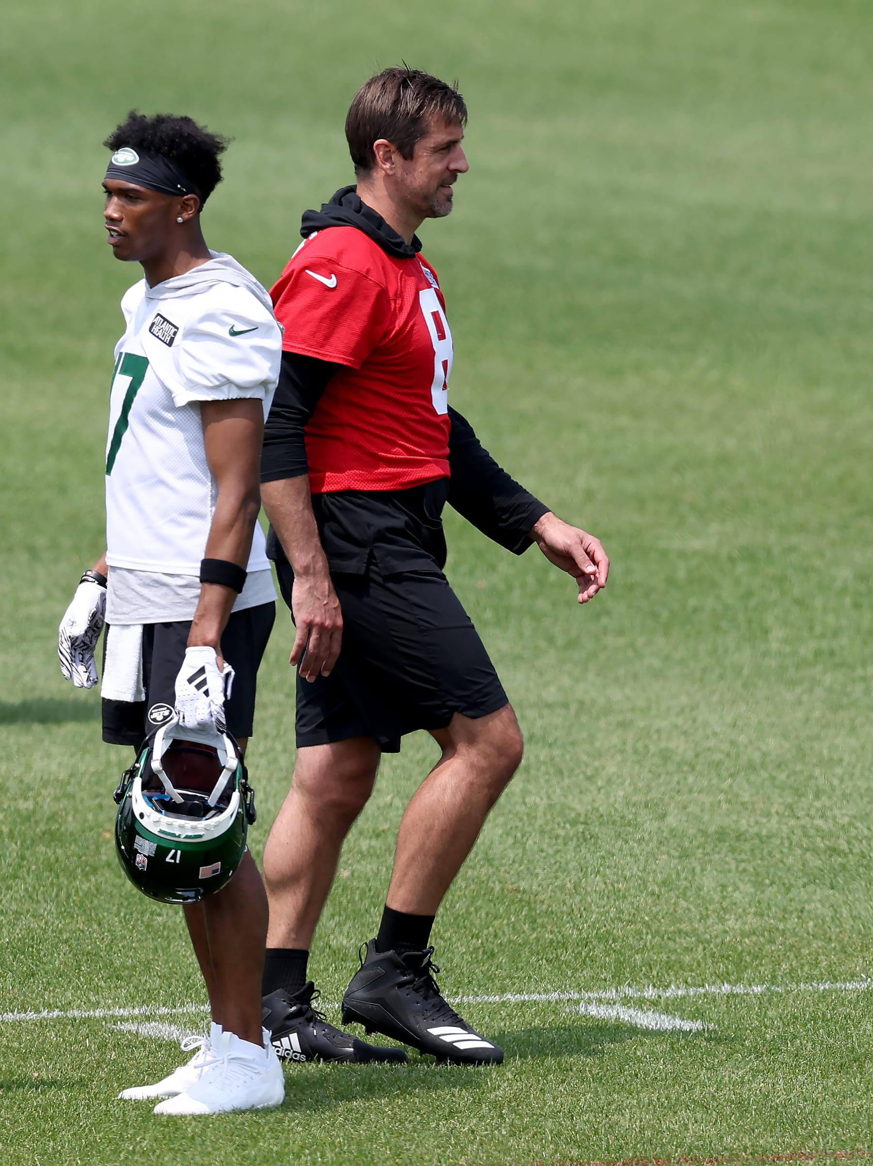 FLORHAM PARK, NEW JERSEY - MAY 23: Garrett Wilson #17 and Aaron Rodgers #8 of the New York Jets walk on the field during an offseason workout session at Atlantic Health Jets Training Center on May 23, 2023 in Florham Park, New Jersey. (Photo by Elsa/Getty Images)