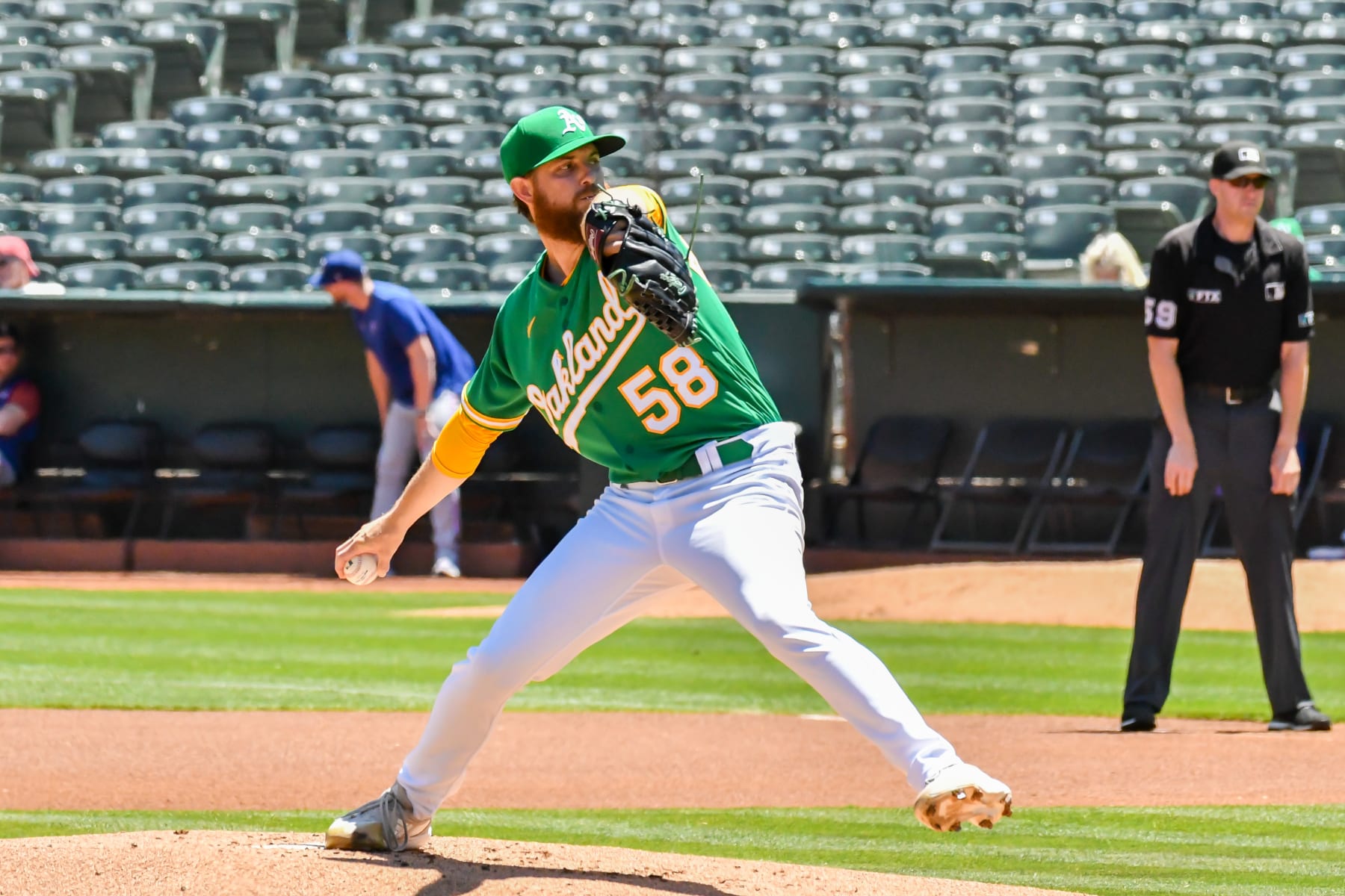 OAKLAND, CA - JULY 24: Oakland Athletics starting pitcher Paul Blackburn (58) pulls back in a delivery during the game between the Texas Rangers and the Oakland Athletics on Sunday, July 24, 2022 at the Oakland Coliseum in Oakland, California. (Photo by Douglas Stringer/Icon Sportswire via Getty Images)