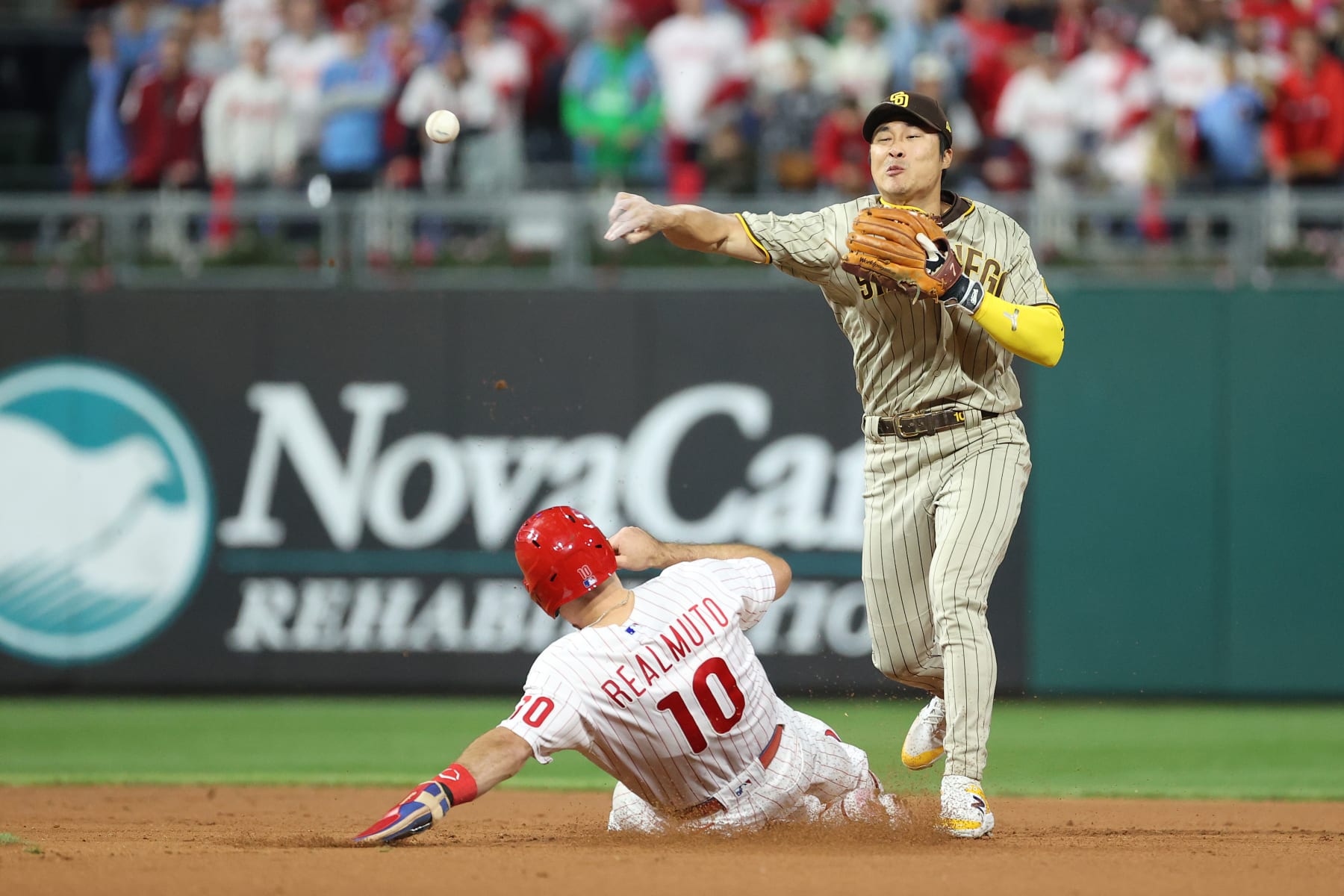 PHILADELPHIA, PENNSYLVANIA - OCTOBER 21: Ha-Seong Kim #7 of the San Diego Padres turns a double play during the first inning against the Philadelphia Phillies in game three of the National League Championship Series at Citizens Bank Park on October 21, 2022 in Philadelphia, Pennsylvania. (Photo by Tim Nwachukwu/Getty Images)