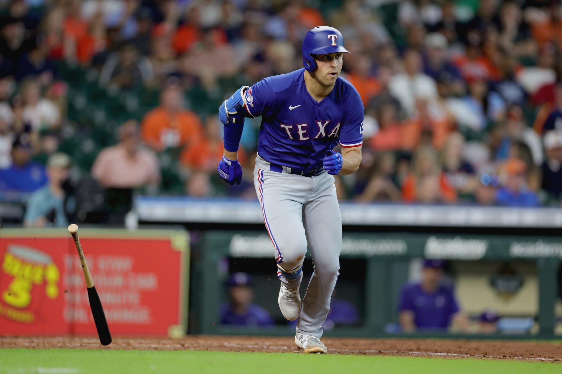 HOUSTON, TEXAS - AUGUST 11: Nathaniel Lowe #30 of the Texas Rangers hits an RBI single during the eighth inning against the Houston Astros at Minute Maid Park on August 11, 2022 in Houston, Texas. (Photo by Carmen Mandato/Getty Images)