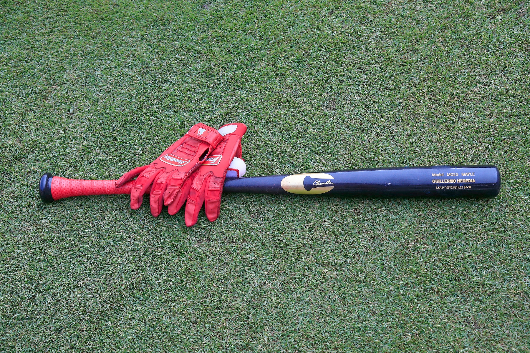 ATLANTA, GA - AUGUST 02: The batting gloves and baseball bat of Atlanta Braves left fielder Guillermo Heredia (38) on the field before the Tuesday evening MLB game between the Atlanta Braves and the Philadelphia Phillies on August 2, 2022 at Truist Park in Atlanta, Georgia.  (Photo by David J. Griffin/Icon Sportswire via Getty Images)