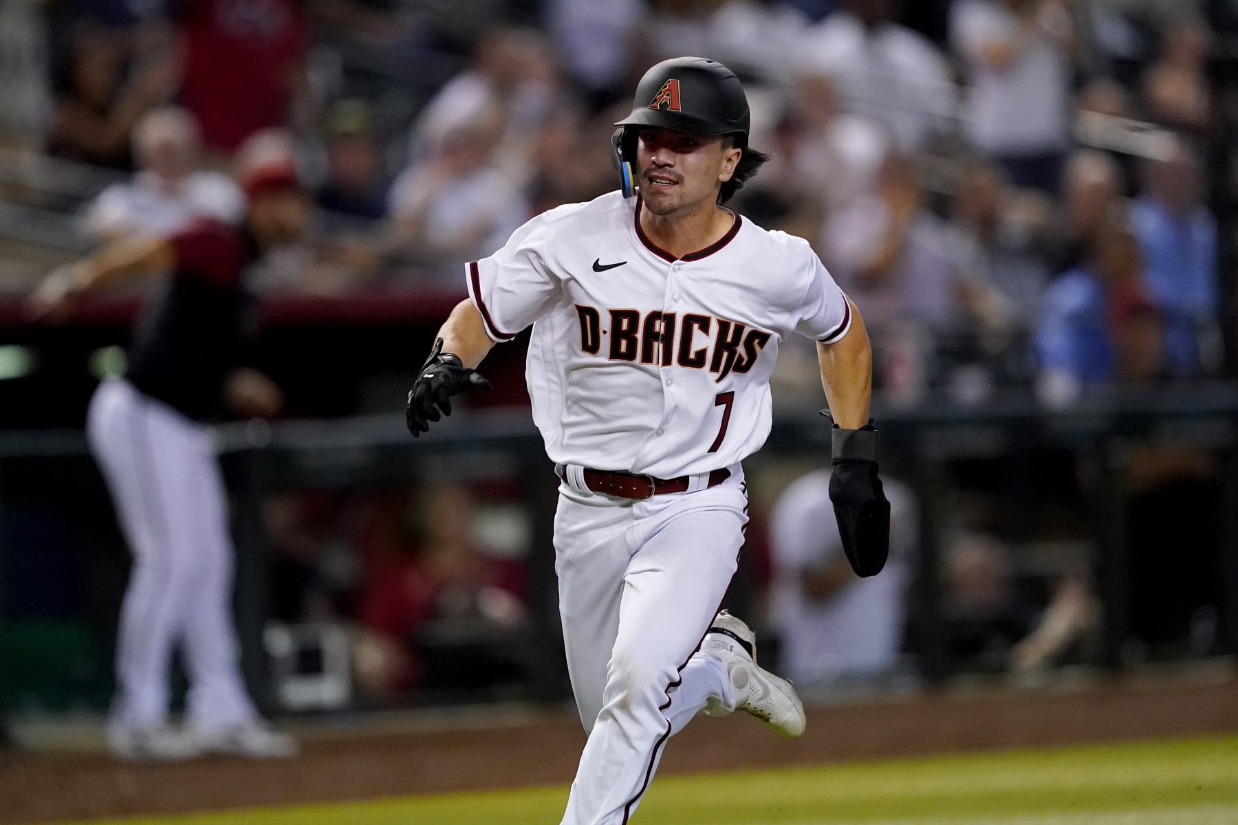 Arizona Diamondbacks' Corbin Carroll scores on a double by Carson Kelly during the fourth inning of a baseball game against the Philadelphia Phillies, Monday, Aug. 29, 2022, in Phoenix. (AP Photo/Matt York)