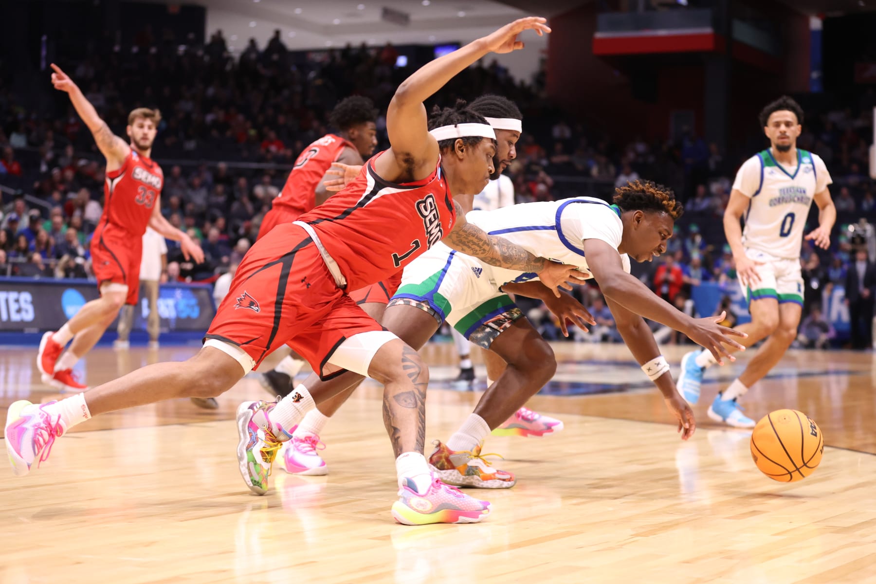 DAYTON, OH - MARCH 14: Phillip Russell #1 of the Southern Missouri State Redhawks and Jalen Jackson #4 of the Texas A&M Corpus Christi Islanders chase the ball during the First Four round of the 2023 NCAA Men's Basketball Tournament held at UD Arena on March 14, 2023 in Dayton, Ohio. (Photo by Tyler Schank/NCAA Photos via Getty Images)