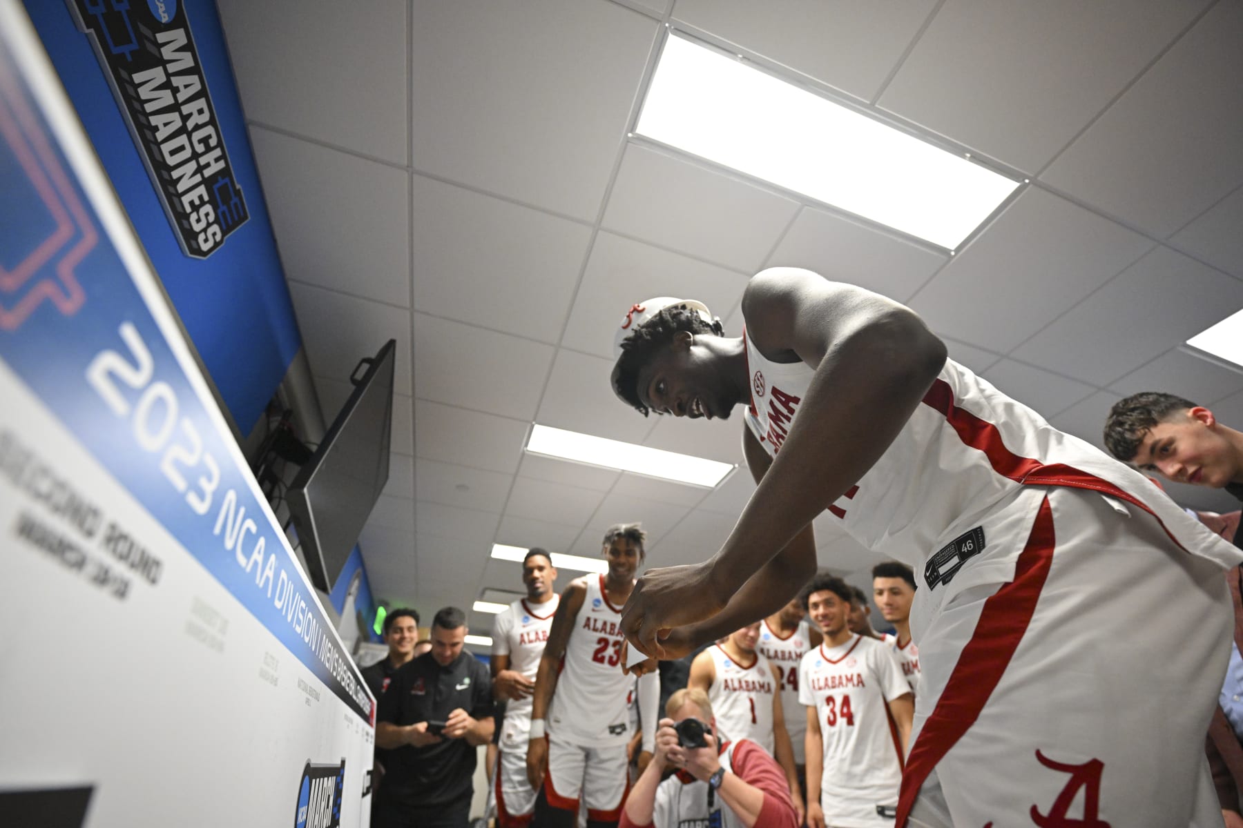 BIRMINGHAM, AL - MARCH 18: Charles Bediako #14 of the Alabama Crimson Tide moves Alabamas name plate to the Sweet Sixteen after win against the Maryland Terrapins during the second round of the 2023 NCAA Men's Basketball Tournament held at Legacy Arena at the BJCC on March 18, 2023 in Birmingham, Alabama. (Photo by Andy Hancock/NCAA Photos via Getty Images)