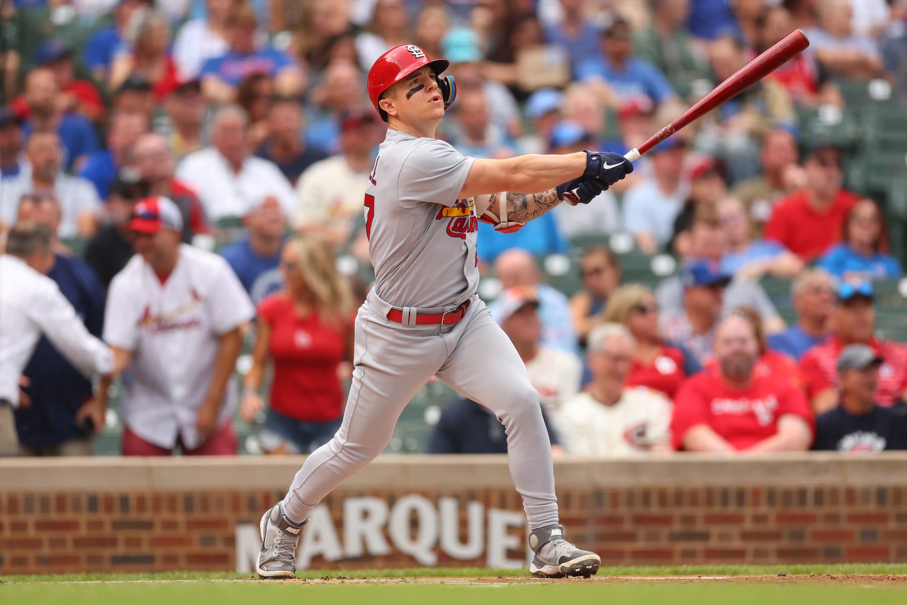 CHICAGO, ILLINOIS - AUGUST 25: Tyler O'Neill #27 of the St. Louis Cardinals hits a RBI sacrifice fly against the Chicago Cubs during the first inning at Wrigley Field on August 25, 2022 in Chicago, Illinois. (Photo by Michael Reaves/Getty Images)