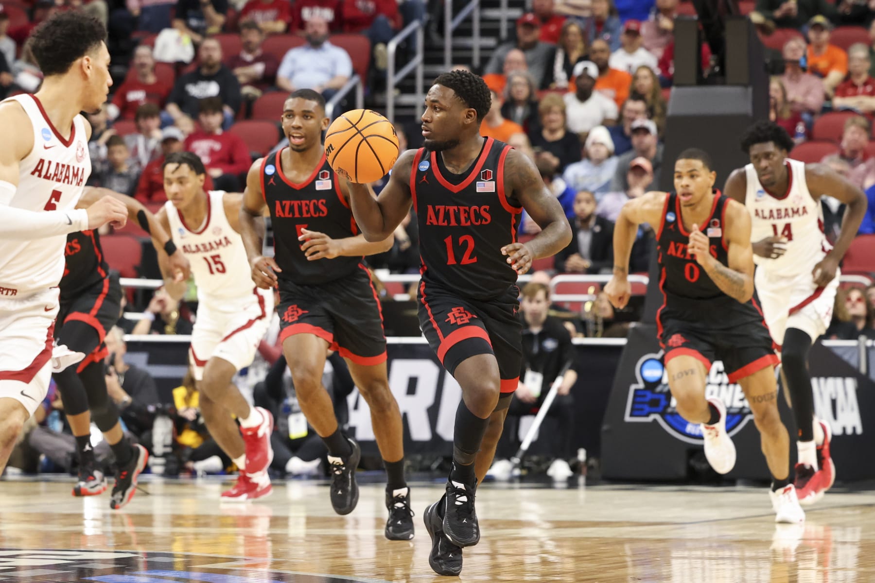 LOUISVILLE, KY - MARCH 24: Darrion Trammell #12 of the San Diego State Aztecs dribbles the ball up the court against the Alabama Crimson Tide during the Sweet Sixteen round of the 2022 NCAA Men's Basketball Tournament held at KFC YUM! Center on March 24, 2023 in Louisville, Kentucky. (Photo by Joe Robbins/NCAA Photos via Getty Images)