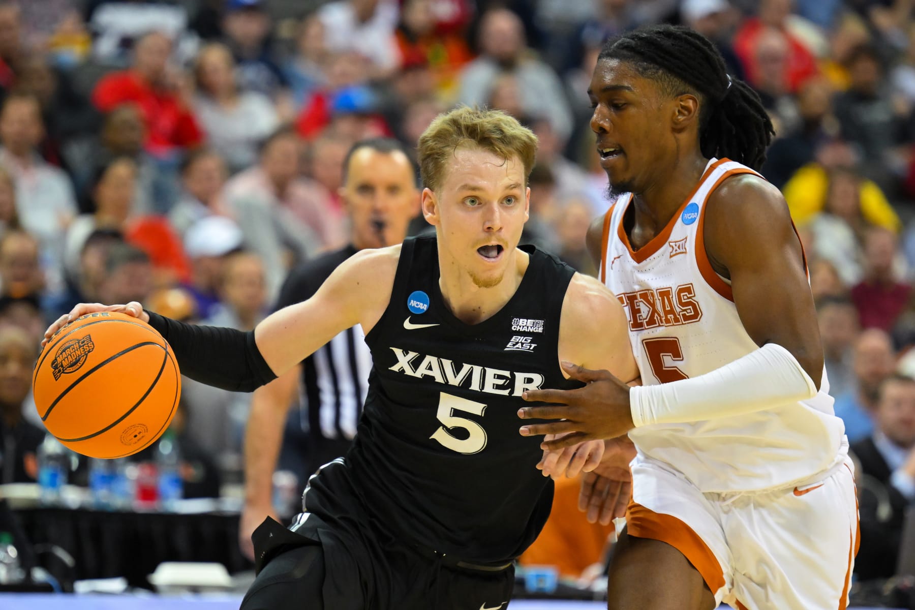 KANSAS CITY, MO - MARCH 24: Guard Adam Kunkel #5 of the Xavier Musketeers dribbles the ball against guard Marcus Carr #5 of the Texas Longhorns during the Sweet Sixteen round of the 2023 NCAA Men's Basketball Tournament Midwest Regionals held at T-Mobile Center on March 24, 2023 in Kansas City, Missouri. (Photo by Andrew Hancock/NCAA Photos via Getty Images)