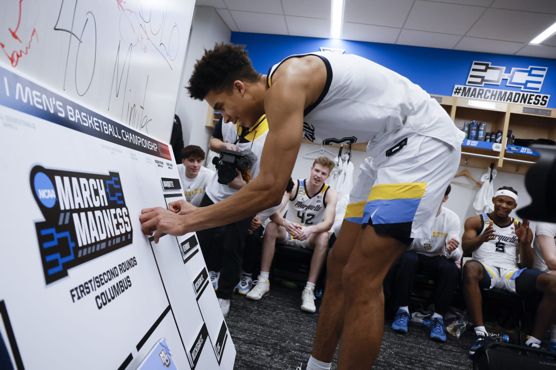 COLUMBUS, OH - MARCH 17: Oso Ighodaro #13 places Marquette into the next slot of the bracket after the teams win over Vermont Catamounts during the first round of the 2023 NCAA Men's Basketball Tournament held at Nationwide Arena on March 17, 2023 in Columbus, Ohio. (Photo by Jay LaPrete/NCAA Photos via Getty Images)
