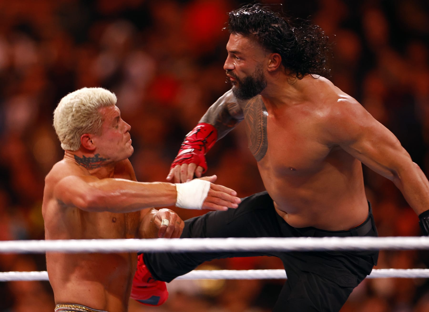 INGLEWOOD, CALIFORNIA - APRIL 02:  (L-R) Cody Rhodes wrestles Roman Reigns for Undisputed WWE Universal Title Match during WrestleMania Goes Hollywood at SoFi Stadium on April 02, 2023 in Inglewood, California.
 (Photo by Ronald Martinez/Getty Images)