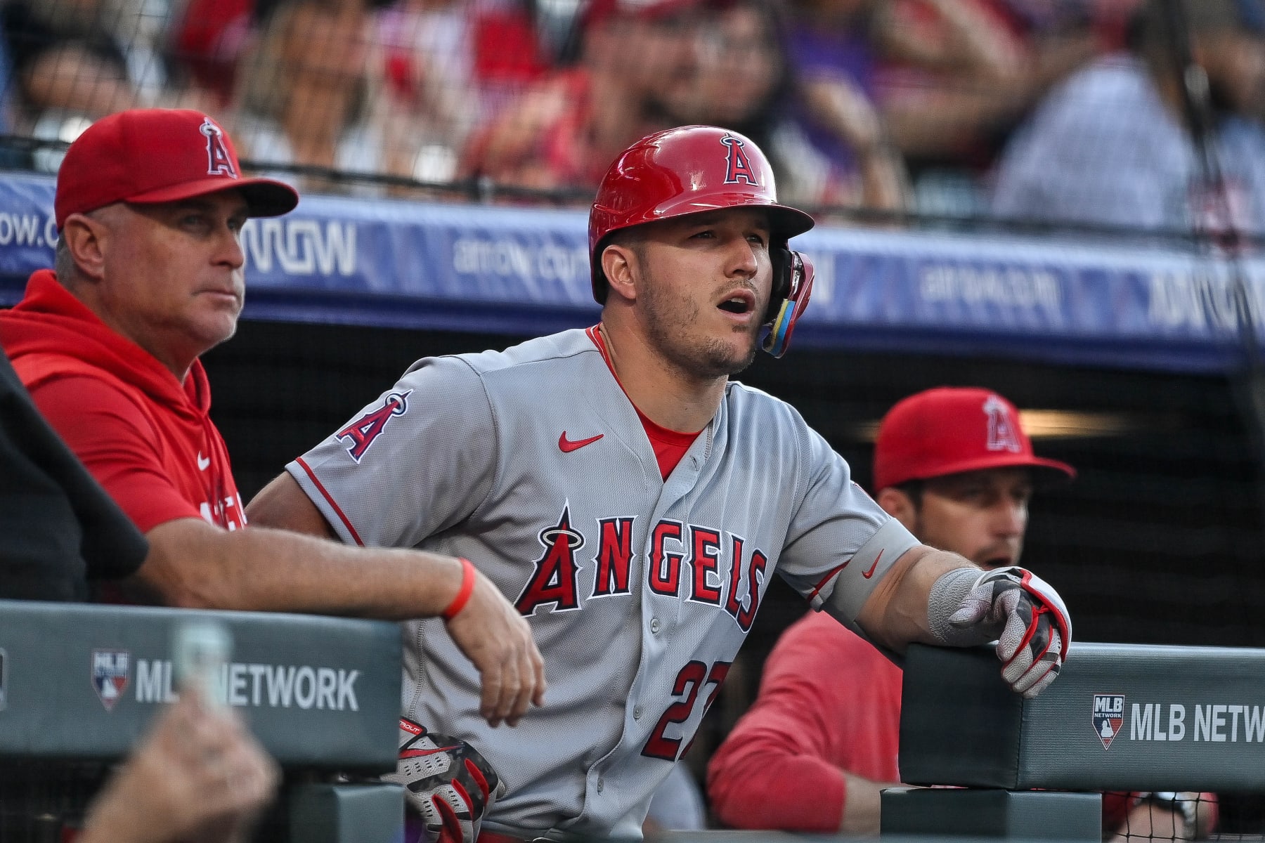 DENVER, CO - JUNE 24: Mike Trout #27 and Phil Nevin #88 of the Los Angeles Angels look on from the dugout in the first inning of a game against the Colorado Rockies at Coors Field on June 24, 2023 in Denver, Colorado. (Photo by Dustin Bradford/Getty Images)