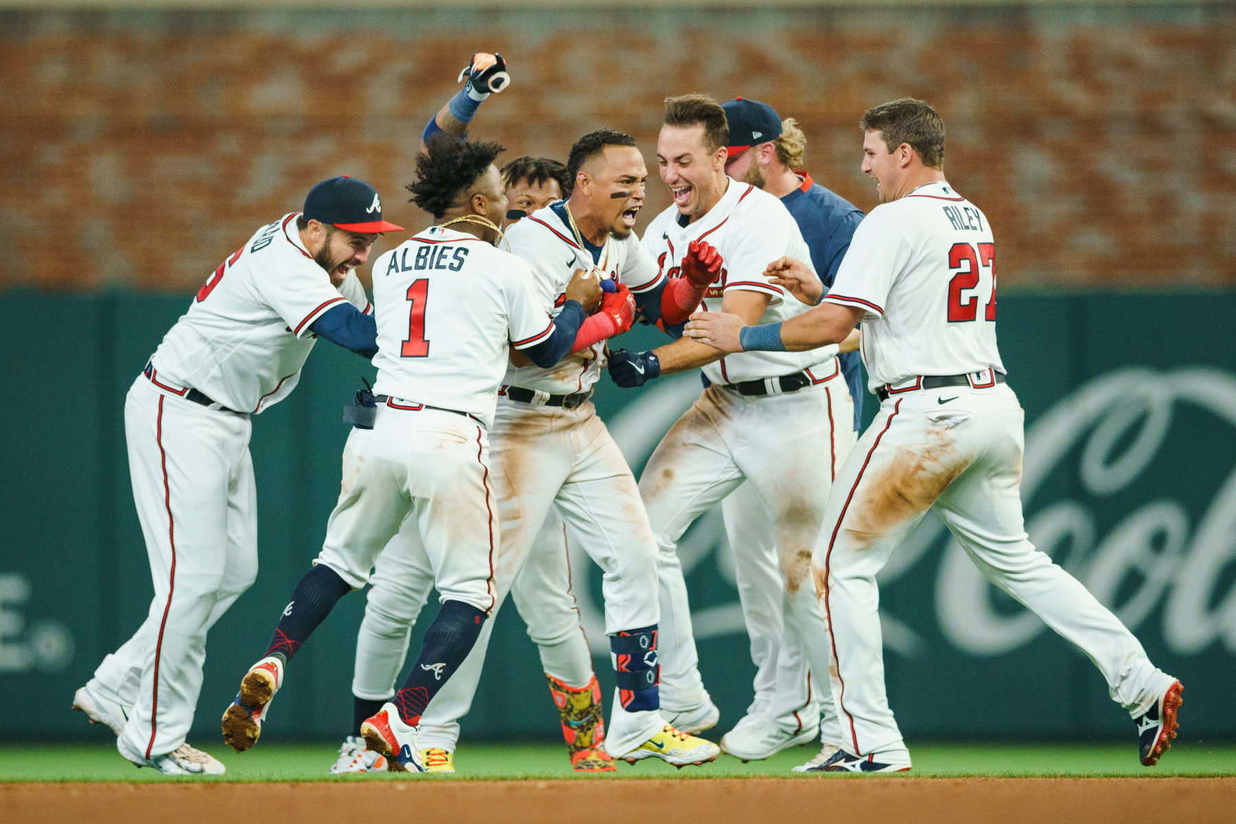 ATLANTA, GEORGIA - APRIL 06: Orlando Arcia #11 of the Atlanta Braves celebrates hitting a walk-off single in the ninth inning with Ronald Acuna Jr. #13, Ozzie Albies #1, Travis d'Arnaud #16, Matt Olson #28, A.J. Minter #33, and Austin Riley #27 against the San Diego Padres at Truist Park on April 06, 2023 in Atlanta, Georgia. (Photo by Matthew Grimes/Atlanta Braves/Getty Images)