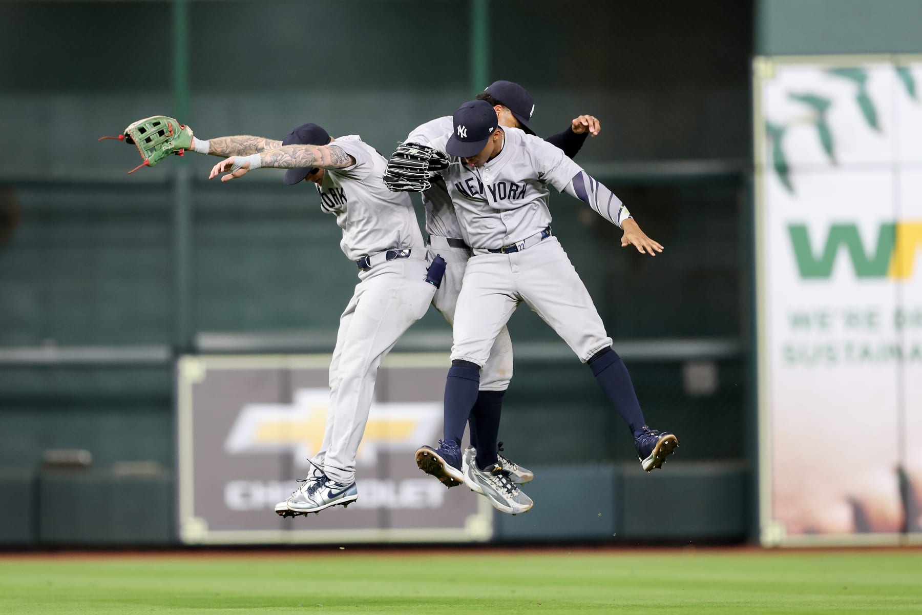 HOUSTON, TEXAS - MARCH 30: Alex Verdugo #24 of the New York Yankees, Trent Grisham #12, and Juan Soto #22 celebrate after defeating the Houston Astros at Minute Maid Park on March 30, 2024 in Houston, Texas. (Photo by Tim Warner/Getty Images)