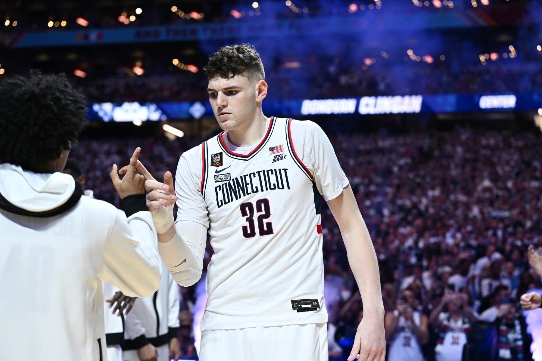 GLENDALE, ARIZONA - APRIL 06: Donovan Clingan #32 of the Connecticut Huskies high fives teammates prior to the first half in the NCAA Men’s Basketball Tournament Final Four semifinal game at State Farm Stadium on April 06, 2024 in Glendale, Arizona. (Photo by Brett Wilhelm/NCAA Photos via Getty Images)