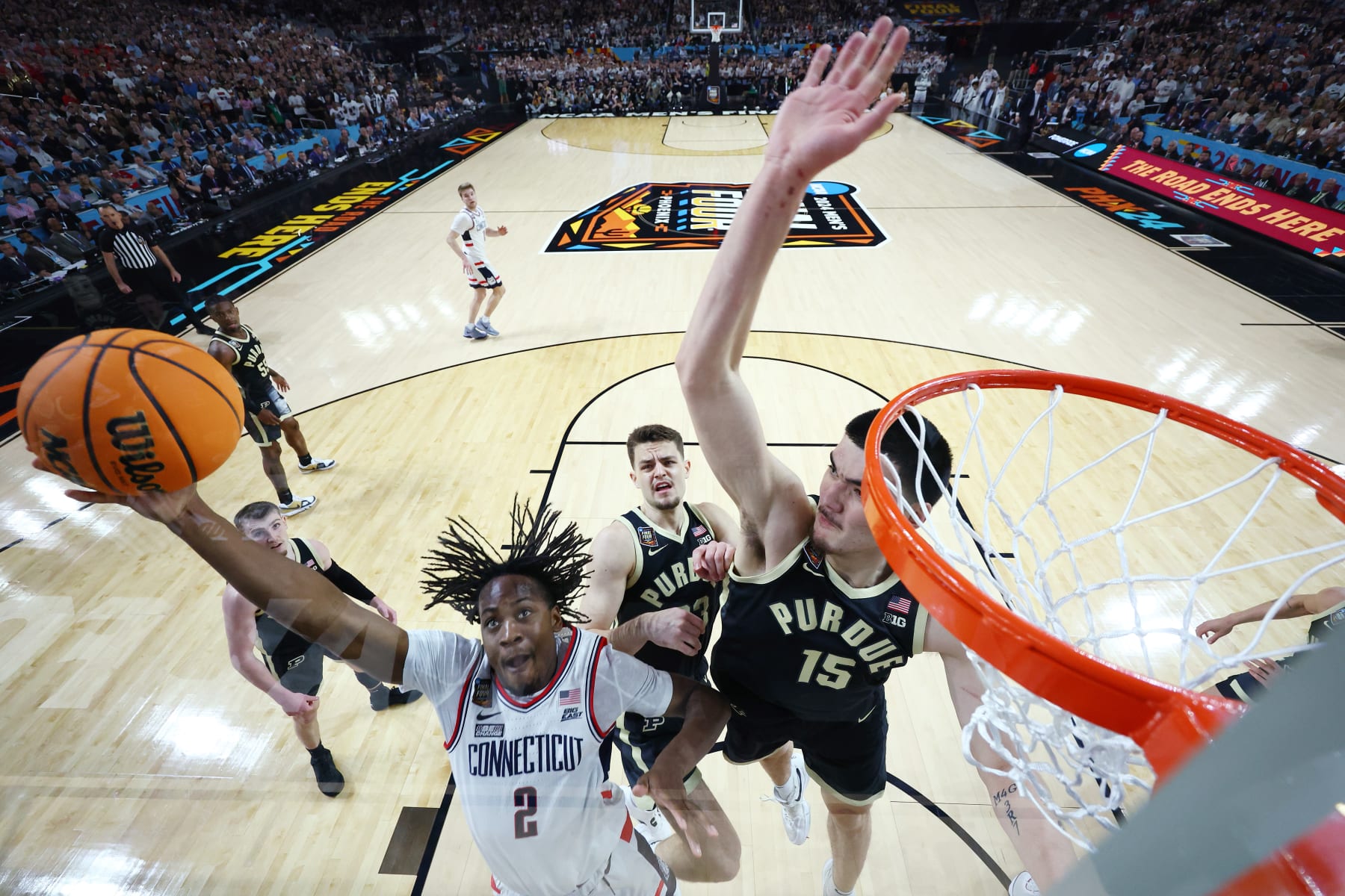 GLENDALE, ARIZONA - APRIL 08: (EDITORS NOTE: Image taken using a remote camera.) Tristen Newton #2 of the Connecticut Huskies shoots with Zach Edey #15 of the Purdue Boilermakers defending during the first half in the NCAA Men's Basketball Tournament National Championship game at State Farm Stadium on April 08, 2024 in Glendale, Arizona. (Photo by Brett Wilhelm/NCAA Photos via Getty Images)