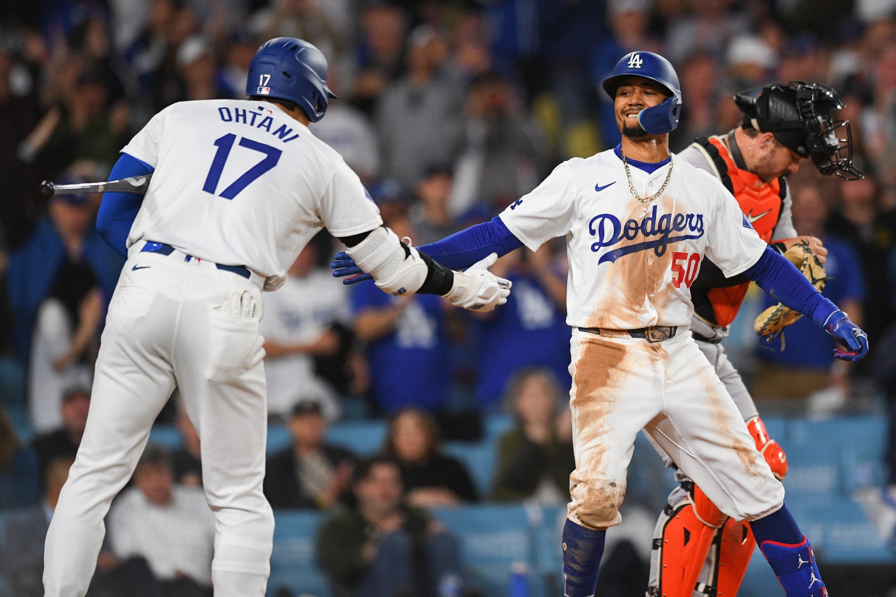 LOS ANGELES, CA - APRIL 02: Los Angeles Dodgers shortstop Mookie Betts (50) celebrates with Los Angeles Dodgers designated hitter Shohei Ohtani (17) after hitting a home run during the MLB game between the San Francisco Giants and the Los Angeles Dodgers on April 2, 2024 at Dodger Stadium in Los Angeles, CA. (Photo by Brian Rothmuller/Icon Sportswire via Getty Images)