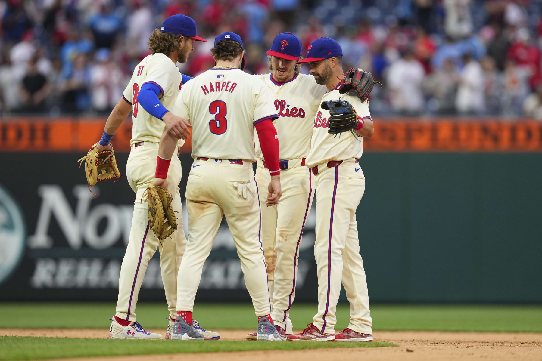 PHILADELPHIA, PENNSYLVANIA - MAY 6: Alec Bohm #28 of the Philadelphia Phillies celebrates with Bryce Harper #3, Bryson Stott #5, and Whit Merrifield #9 against the San Francisco Giants at Citizens Bank Park on May 6, 2024 in Philadelphia, Pennsylvania. The Phillies defeated the Giants 6-1. (Photo by Mitchell Leff/Getty Images)