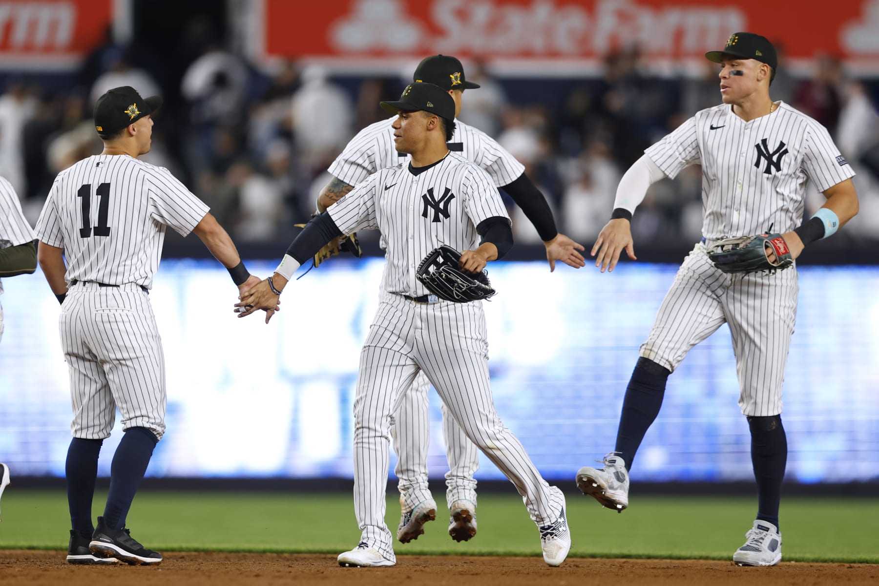 NEW YORK, NEW YORK - MAY 17: Anthony Volpe #11, Juan Soto #22 and Aaron Judge #99 of the New York Yankees celebrate after defeating the Chicago White Sox 4-2 in a game at Yankee Stadium on May 17, 2024 in the Bronx borough of New York City. (Photo by Rich Schultz/Getty Images)