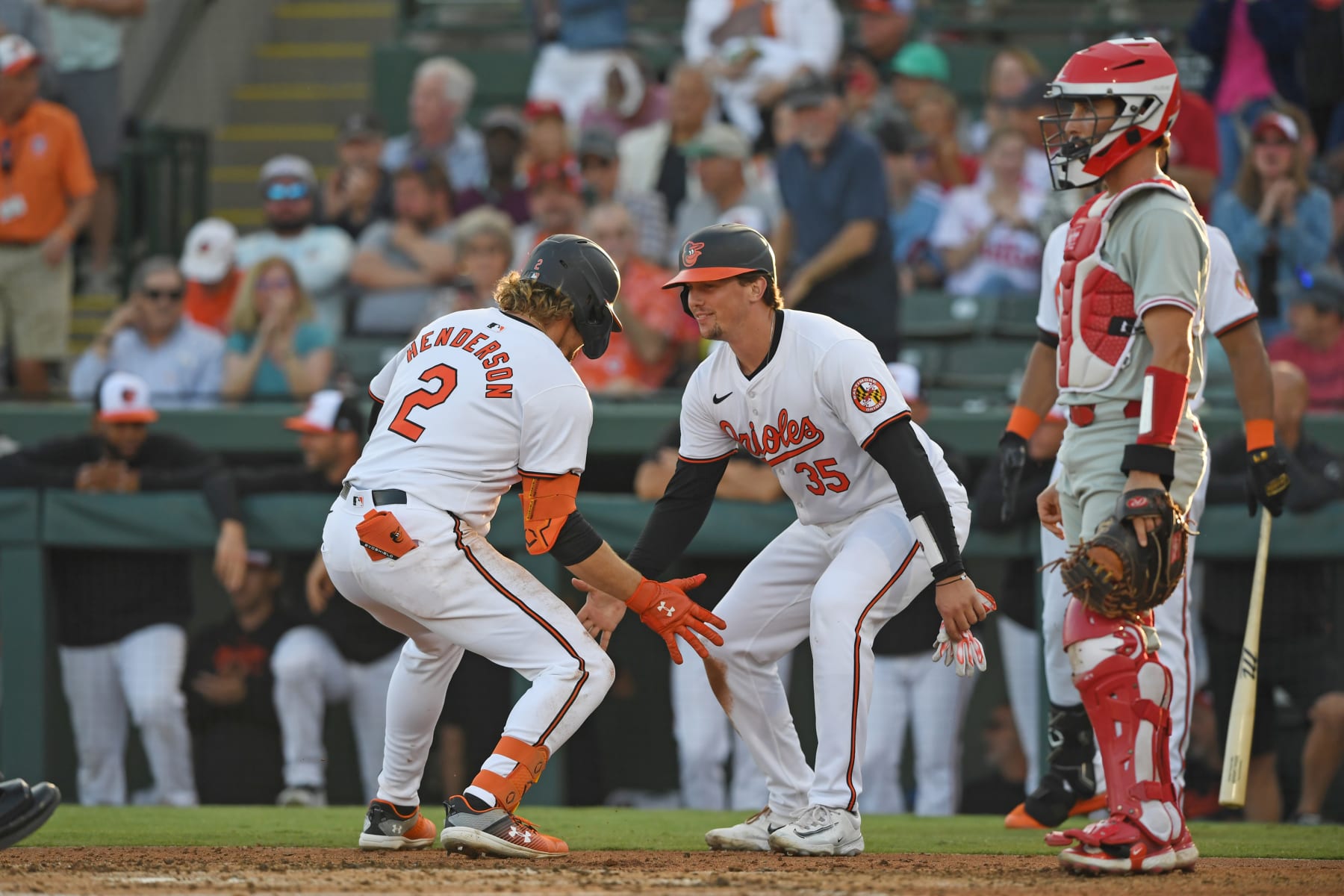 SARASOTA, FLORIDA - MARCH 20, 2024: Adley Rutschman #35 and Gunnar Henderson #2 of the Baltimore Orioles celebrate a two-run home run hit by Henderson during the second inning of a spring training game against the Philadelphia Phillies at Ed Smith Stadium on March 20, 2024 in Sarasota, Florida. (Photo by George Kubas/Diamond Images via Getty Images)